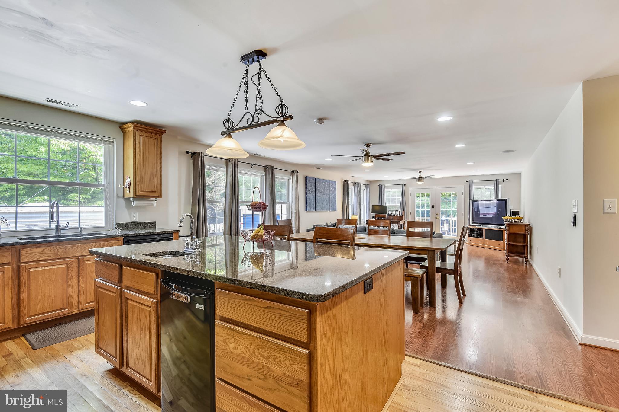 Contemporary updates to this classic brick home on a quiet cul-de-sac. The great room includes a spectacular kitchen, generous dining area & sunlit family room with French doors leading to the expansive deck. The kitchen features granite counter-tops, huge center island with separate sink & breakfast bar, updated appliances and pendent lighting. The master bedroom offers a large walk-in closet and glass doors to the deck. The newly renovated master bath includes a shower, separate soaking tub & comfort height vanity. Lower level offers a second kitchen, full bath, two versatile rooms plus a cozy recreation room with gas fireplace. ** Pool Membership in Poplar Heights Recreation Association may transfer with property for a fee **.