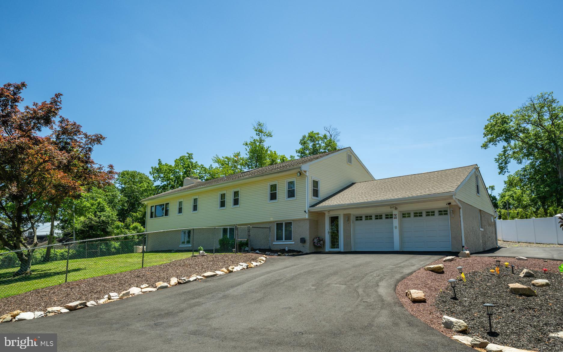 Welcome home to this versatile 5 bedroom Bi Level home featuring a separate lower level IN LAW SUITE / apartment on sprawling one acre lot in Yardley, with in ground pool!  This home is the rare find that checks every box — whether you're looking to keep family close or simply have the space and flexibility to live life on your terms. The moment you step inside, you’ll notice the thoughtful upgrades, neutral color palette and functional living space throughout. The private lower level suite greets you on the main level, offering complete independence with its own living room, a kitchenette with peninsula complete with granite countertops for casual dining, a spacious bedroom with plush carpeting and an oversized closet, a full bathroom with stall shower, and its own washer and dryer. It even has its own private entrance to the backyard!  The possibilities for this space are endless- perfectly suited as an in law suite, home office, or guest retreat! Head upstairs to the main living area, where a bonus room on your right offers endless possibilities and can be used as a home office, playroom or gym. Down the hall, four spacious bedrooms all feature ceiling fans and an abundance of natural light. Two of the bedrooms share a convenient Jack-and-Jill half bath, ideal for kids or guests. The family room is truly unique — featuring built-in shelving, exquisite ceiling trim, rich wood details throughout, a cozy wood-burning fireplace AND direct access to the sun porch! Take a few steps further to your completely updated eat in kitchen showcasing BRAND NEW appliances, new cabinetry, sleek Corian countertops, a dining area AND direct access to the sun porch for effortless entertainment. Step out to your sun porch complete with wall-to-wall windows and ceiling fan - the perfect spot for your morning coffee. Outside, your backyard oasis offers a true retreat. Fully fenced with private vinyl fencing, the expansive lot is designed for making memories. Unwind on the Trex deck, host family and friends for backyard barbecues, gather around the fire pit and chimney on cool evenings, or enjoy lawn games across the expansive yard.  Continue to your front side yard where summer really comes alive — featuring your very own in-ground pool! The ideal space for cooling off on a hot afternoon or hosting poolside gatherings with family and friends! Other upgrades include NEW pool liner and cover, NEW flooring, High Efficiency heaters, replaced windows and doors on porch, NEW garage doors and openers and NEW driveway! This truly unique home offers the highly sought-after flexibility of multigenerational living, all while being conveniently located near a variety of shopping and dining. Close to Yardley Station with direct service to Center City, Trenton Mercer Airport, and I 295 for easy commuting! Pennsbury School District too! Don’t miss you opportunity to see this amazing home today!