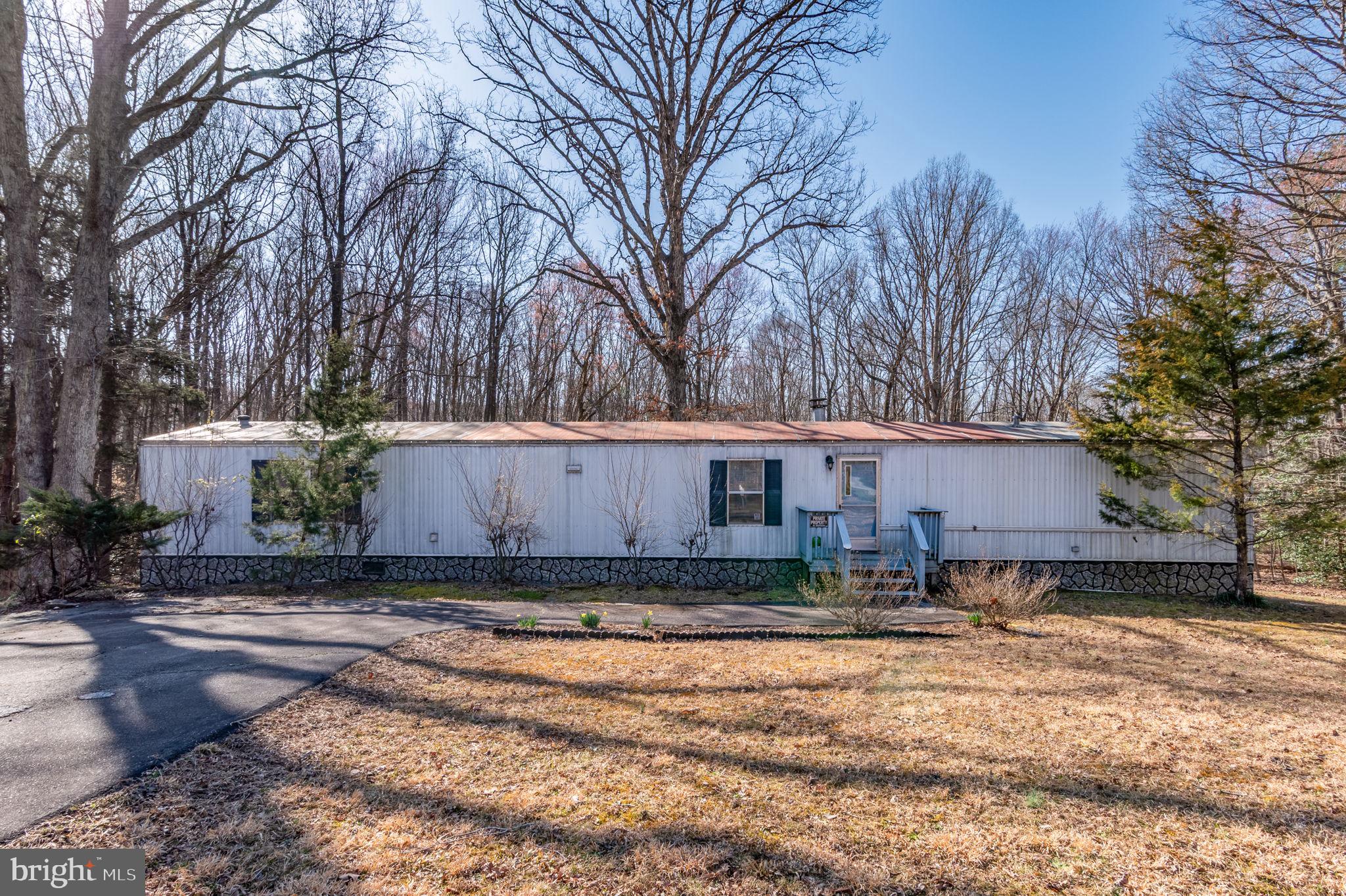 Nestled on 3.42 acres in Goochland County, this property offers privacy and a serene natural setting. A paved driveway leads you to a well-maintained home with an open floor plan and a split bedroom design. The primary suite features a luxury bath and walk-in closet, while two additional bedrooms share a hall bath on the opposite side. The spacious eat-in kitchen provides ample cabinetry, and the cozy family room is enhanced by a corner wood-burning fireplace, perfect for chilly nights. Additional highlights include a detached storage shed and a deep well. Enjoy the peaceful surroundings where you can watch the seasons change and wildlife roam.