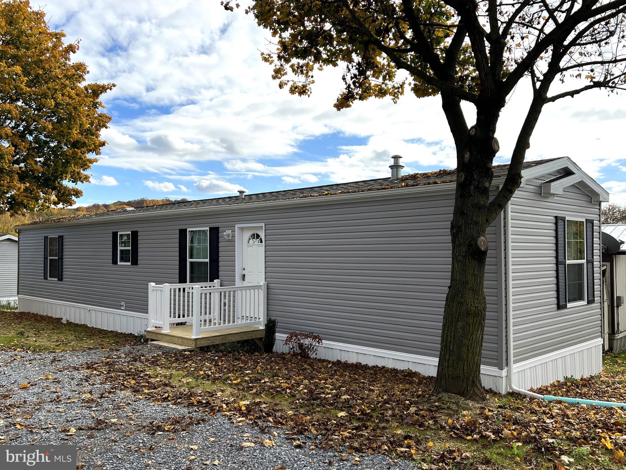 Brand new 2 bedroom 2 bath single wide on a beautiful setting with two shade trees. This home has a beautiful, bright floor plan and features a modern décor accented with dark wood trim and crown molding throughout to match the cabinetry. Some of the more notable aspects include recessed lighting, double pane insulated windows, and brand new stainless steel Whirlpool appliances which include a dishwasher, fridge/freezer, built-in microwave, and 4-burner propane stove. The eat-in kitchen has plenty of cabinet/shelf space, double bowl stainless steel sink and an outside exit. The primary bathroom has a large vanity and a sliding glass door shower. This home has washer/dryer hookups and is serviced by propane forced air heat, central air conditioning, community water and public sewer. Lot rent is only $430/month which includes water, sewer, trash and snow removal. A stone pad has been installed for placing a shed. Pets are allowed per park approval at $15/month per pet. This is a great opportunity to own a brand new home in a good community just minutes from Rts 222 and 272.