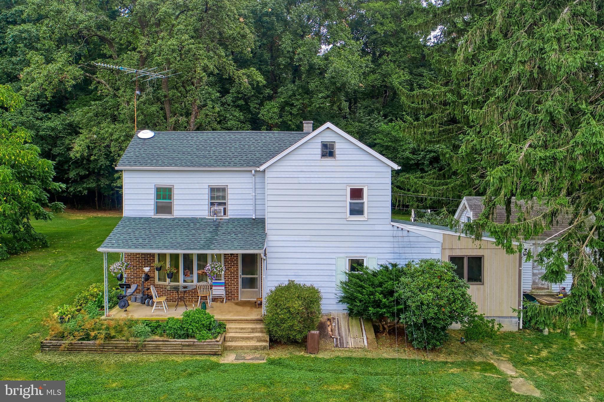 This is your chance at having your own piece of country living! This 2 bedroom 1 bathroom Farmhouse situated only miles from 83 and Maryland, in Southern York County is nestled on 6.8 acres; complete with large block garage, multiple outbuildings, original outdoor summer kitchen and a small pond with walk-bridge. Featuring acres of fenced pastures, riding ring and single-stall barn with built-in chicken coop, this land is ready to accommodate all of your furry friends. Large detached 2,000 sq. ft block garage with finished cement floors and 16 ft. wide door. From cement floor to ceiling rafters 13 1/2 ft clearance, outfitted with two fuel tanks with working pumps, 110 & 220 volt outlets; the possibilities are endless. With a new roof and rain gutters, new furnace, upgraded kitchen appliances and renovated bathroom, along with it's charm, picturesque landscape and meticulously maintained pastures , you will see why country living is for you!