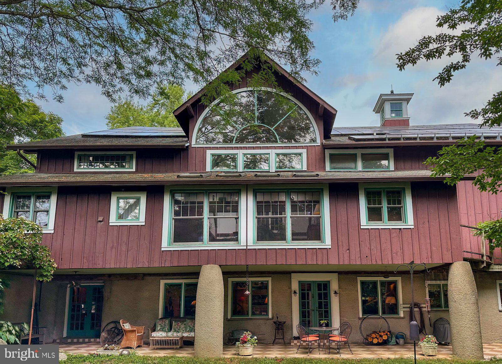 Welcome to 113 Cumberland Place, a breathtaking multi-year renovation of a banked dairy barn, nestled in the coveted neighborhood of Bryn Mawr, PA.  This extraordinary home boasts an impressive 6,000 square feet of living space, combining rustic charm with modern amenities. The multi-story converted hay loft area offers incredible flexibility for hobbies, car collecting, woodworking, trades work, and indoor recreation, supported by 4 propane heaters in a spacious two-story open area. A push/pull trolley under the ridge beam offers direct access to the cupolas and roof, adding to the home’s unique charm. Situated on .42 acres of serene, lush grounds, this residence features 4 well-appointed bedrooms and 3 full baths. A unique highlight is the Lafayette Loft, a two-story Airbnb suite with living space, full bathroom, and loft area with bed, generating an additional $23,000 per year. The hay loft has a separate entrance, adding to the home’s versatility. A main floor Saltillo tile entrance offers multi-purpose space that could be an additional Airbnb guest room, office or studio, previously housing an architectural firm.  The living/dining areas feature hand sanded old growth Pennsylvania pine floors and a three-story atrium that floods the space with light. The all-white kitchen is equipped with granite countertops and a wood block island. There is a four-burner Wolf gas cooktop, a Thermador oven, and Kitchen Aid dishwasher making it an efficient cooking area. On the second floor a sunroom with 4 skylights, Saltillo tile floor, and laundry room connect the two bedroom areas. The primary suite featuring a vaulted ceiling and a dressing room expansion offers abundant closet space. The generous bedrooms offer ample closets, while various nooks and crannies provide additional storage solutions for a clutter-free living experience. Located within the highly regarded Radnor Township School District, this property is ideal for families seeking a distinctive living experience. This home is steeped in history, with a covered front patio and beams and timbers that tell a story. Now, it’s ready for you to write the next chapter. Don’t miss our exclusive website for this home, featuring a 3D Matterport tour, Virtual Reality Walkthrough, detailed floor plan, professional photography, and aerial drone footage. Note: Some photos have been digitally enhanced. Additional features include spiral staircases, many of the floors are hand sanded barn wood, beamed ceilings, Dutch doors, two custom-built cupolas, and 88 solar panels providing significant electric savings. Conveniently located near downtown Bryn Mawr and Wayne, with access to shopping, upscale restaurants, and top healthcare systems. Easy access to King of Prussia Mall, Rt. 476, Rt. 76, PA Turnpike, and I-95 to Philadelphia International Airport. Hurry to make this your new Main Line heritage home!