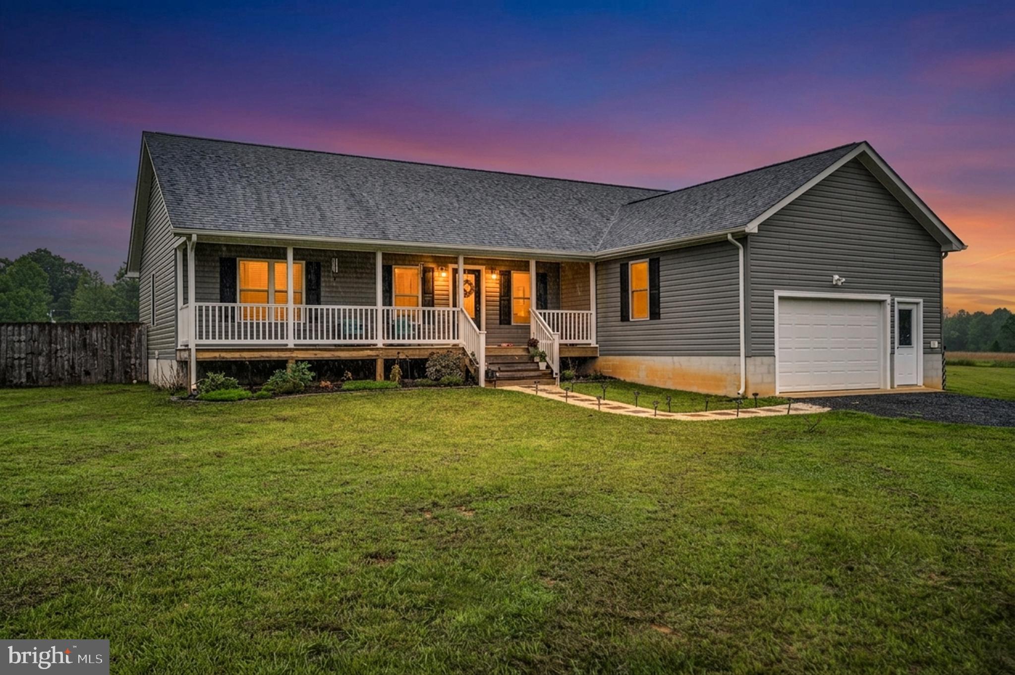 Picture yourself pulling into the driveway at 7295 Cornfield Lane, where 4.14 open acres welcome a slower pace and a chance to enjoy the simple pleasures of country living. Here in Rhoadesville, the peaceful setting creates a sense of calm from the moment you arrive.

Before you even step inside, the charming front porch invites you to sit for a while and take in the surroundings. It's the kind of place where mornings begin with a cup of coffee, evenings end with a quiet conversation, and the sounds of birds chirping provide the soundtrack to your day.

Inside, the one-level floor plan makes everyday living effortless. Luxury vinyl plank flooring flows throughout the home, while the open-concept living room, dining area, and kitchen create a spacious gathering place where everyone can stay connected. Whether you're preparing a meal, helping with homework at the breakfast bar, or hosting friends for dinner, the layout keeps life moving comfortably from one space to the next.

The kitchen serves as the heart of the home with its center island and breakfast bar, offering plenty of room for casual meals and conversation. A pantry provides convenient storage, helping keep everything organized and within reach.

The primary bedroom is thoughtfully positioned on the opposite side of the home from the additional bedrooms, creating a private retreat at the end of the day. The separation offers a sense of space and privacy while maintaining the convenience of one-level living.

Outside, the fenced backyard is ready for everyday enjoyment. The deck provides a natural extension of the living space, perfect for grilling, relaxing, or simply taking in the views of your property. A playground creates a dedicated space for fun and play, while the surrounding acreage offers room to spread out and enjoy the outdoors.

With three bedrooms, two bathrooms, an inviting open floor plan, and 4.14 acres of peaceful countryside, 7295 Cornfield Lane offers the opportunity to enjoy the quiet beauty of rural Virginia while creating a home that feels comfortable, connected, and uniquely your own.