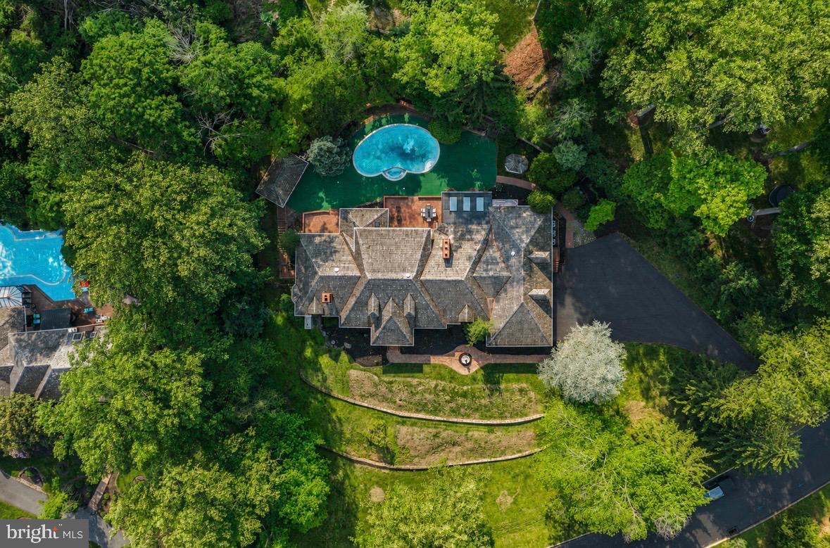 Welcome to 21 Springton Pointe Drive- Newtown Square. A completely renovated  custom built home where attention to detail is highlighted in every room of the house. This beautiful home has 4 bedrooms,  4 full bathrooms and 3 half baths with over 5300 square feet of above grade level living space perfectly situated on a bucolic 1.2 acre lot with a view of Springton Lake. Upon entering you are greeted by a grand foyer adorned with marble floors and a sweeping curved staircase leading to the second floor.   Flanking the foyer to the right is an elegant large  formal dining room with new hard wood flooring. The wide center hallway runs the length of the home connecting all the living areas. The living room is step down and is  adorned with a gas fireplace and new built ins and hardwood floors. The family room also has a gas fireplace and is located  directly off the kitchen. The gourmet  eat-in kitchen features GE Monogram luxury professional grade appliances  with sleek  built in styling and quartz counter tops. The large island is prominently located for entertaining. .Just off the kitchen is a powder room, pantry and a sunroom. The main floor contains an extra bedroom with en suite bath. The grand primary suite  encompasses the entire left side of the home. It includes a beautiful sitting area with a gas fireplace and a coffee/wine bar. The huge primary bathroom includes a steam shower, a free standing tub, his and her vanities and toiletry areas. A generous walk in closet with built ins as well as another closet for linens. The laundry room and another powder room are also located on the first floor. 2 large additional bedrooms are located on the 2nd floor with a custom Jack and jill bathroom and a cozy sitting area for reading and relaxation. The walk out finished lower level consists of approximately 4300 additional sq ft living area. It features all new luxury vinyl flooring installed an additional bedroom/office or gym room, a full bathroom as well as an additional powder room. This exceptional space also includes a handsome wood bar, gas fireplace and a full  brand new kitchen.  The unfinished area features a cedar closet, additional shelving and wine cellar. This home's outdoor space includes brick patios, a gazebo and an in ground pool surrounded by mature plantings. There is a pool house with two changing rooms and a full bathroom. This exceptional home offers the best of both indoor and outdoor living and entertaining. This private retreat is located in the desirable Springton Pointe/Newtown Square community with award wining Marple-Newtown Schools. Located near the vibrant towns of Media Borough and the Ellis Preserve in Newtown Square with upscale dining and shopping,  Minutes to the blue route and airport and a short drive to Philadelphia. Make your appointment today to tour this one of a kind property.