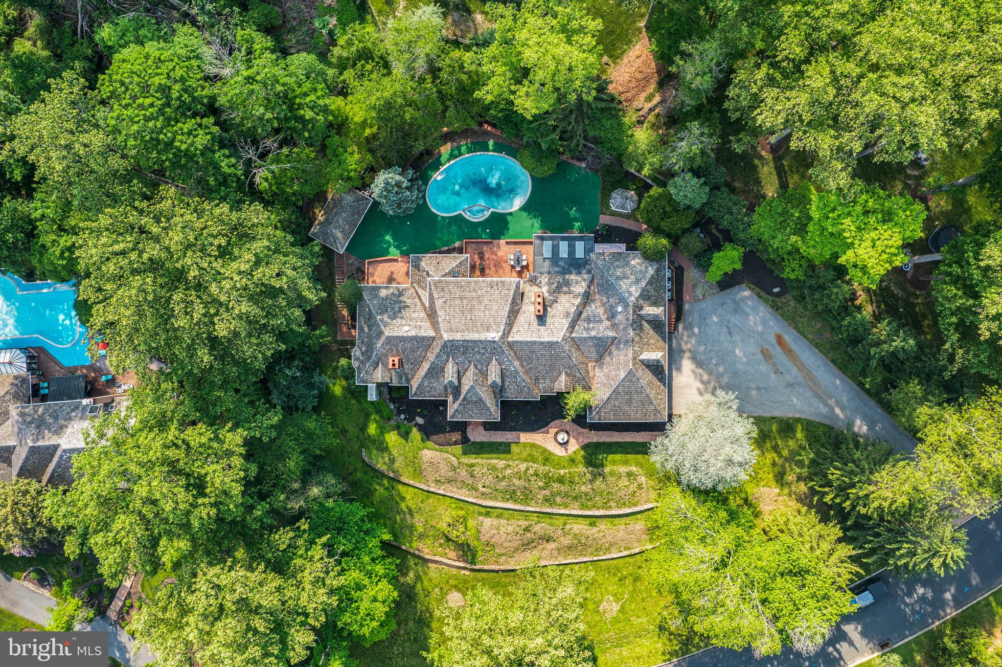 Welcome to 21 Springton Pointe Drive- Newtown Square. A completely renovated  custom built home where attention to detail is highlighted in every room of the house. This beautiful home has 4 bedrooms,  4 full bathrooms and 3 half baths with over 5300 square feet of above grade level living space perfectly situated on a bucolic 1.2 acre lot with a view of Springton Lake. Upon entering you are greeted by a grand foyer adorned with marble floors and a sweeping curved staircase leading to the second floor.   Flanking the foyer to the right is an elegant large  formal dining room with new hard wood flooring. The wide center hallway runs the length of the home connecting all the living areas. The living room is step down and is  adorned with a gas fireplace and new built ins and hardwood floors. The family room also has a gas fireplace and is located  directly off the kitchen. The gourmet  eat-in kitchen features GE Monogram luxury professional grade appliances  with sleek  built in styling and quartz counter tops. The large island is prominently located for entertaining. .Just off the kitchen is a powder room, pantry and a sunroom. The main floor contains an extra bedroom with en suite bath. The grand primary suite  encompasses the entire left side of the home. It includes a beautiful sitting area with a gas fireplace and a coffee/wine bar. The huge primary bathroom includes a steam shower, a free standing tub, his and her vanities and toiletry areas. A generous walk in closet with built ins as well as another closet for linens. The laundry room and another powder room are also located on the first floor. 2 large additional bedrooms are located on the 2nd floor with a custom Jack and jill bathroom and a cozy sitting area for reading and relaxation. The walk out finished lower level consists of approximately 4300 additional sq ft living area. It features all new luxury vinyl flooring installed an additional bedroom/office or gym room, a full bathroom as well as an additional powder room. This exceptional space also includes a handsome wood bar, gas fireplace and a full  brand new kitchen.  The unfinished area features a cedar closet, additional shelving and wine cellar. This home's outdoor space includes brick patios, a gazebo and an in ground pool surrounded by mature plantings. There is a pool house with two changing rooms and a full bathroom. This exceptional home offers the best of both indoor and outdoor living and entertaining. This private retreat is located in the desirable Springton Pointe/Newtown Square community with award wining Marple-Newtown Schools. Located near the vibrant towns of Media Borough and the Ellis Preserve in Newtown Square with upscale dining and shopping,  Minutes to the blue route and airport and a short drive to Philadelphia. Make your appointment today to tour this one of a kind property.