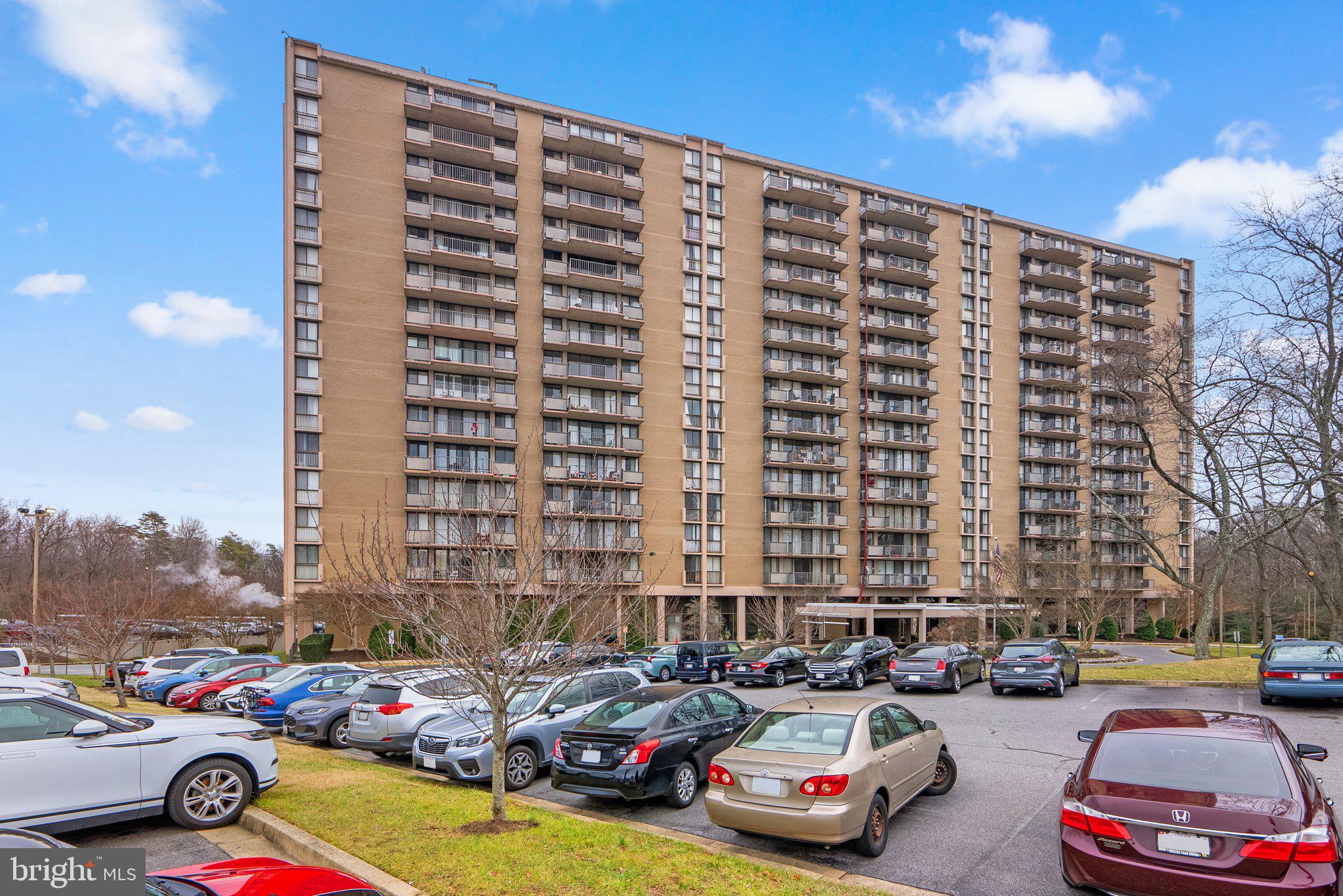 ***ASSESSMENT PAID  IN FULL*** & ***DEEDED PARKING SPACE CONVEYS -(#1 - close to entrance)*** -  Seldom does a unit (close to elevator and common laundry area) become available with SPECTACULAR VIEWS OF THE CITY FROM THE SPACIOUS BALCONY on the 17th floor; Loads of natural sunlight penetrates the Replacement Windows & Sliding Glass Door!   Freshly neutrally painted throughout w/new wall to wall carpet (over parquet), new kitchen LVP,  new dishwasher, matching Window Treatments, new faucets and so much more!  Table Space Kitchen, LR/DR Combo with new fixtures, primary bedroom with ensuite bath and dual closets, second bedroom with hall full bath and loads of storage throughout!  Condo Fee includes all utilities, 24-hr. front desk concierge service, renovated lobby, hair salon, dentist, convenience store, exercise room, library, outdoor pool and overnight security!  Shuttle bus service to University of Maryland and easy access to major transportation routes (95, 495, 295) and Metro and Commuter Rail.  All necessary amenities are  within a 3-4 mile radius and BWI (28.8 miles) and DCA are (17.2 miles). HURRY!