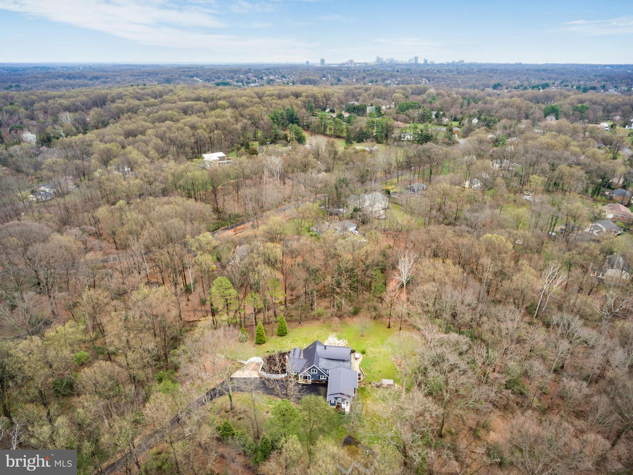 With close to $500,000 in  additions and upgrades, this fabulous custom home was built for those who long for a life surrounded by the great outdoors. It's a true entertainer's paradise nestled away from everyone yet ideally located just minutes to the Vienna Metro and Tysons Corner. With distinctive features throughout, this property offers complete privacy while highlighting a fantastic use of space. The unique floor plan also provides several options for multi-family living with two Primary Suites (one being on the main floor) PLUS a separate 800 sq foot In-Law Suite over the garage featuring a 2nd full kitchen, laundry and private entrance. If you're looking for ultimate peace and relaxation, combined with a one-of-a-kind home and an ABUNDANCE of NATURAL LIGHT, there's no better place than this spacious Vienna retreat! 

 As you enter the home, The MAIN LEVEL boasts a spacious foyer with hardwood flooring and a view into the recently renovated Gourmet Kitchen which is a must see! Featuring Bosh and Thermador appliances, custom cabinetry and exquisite countertops, this space will be enjoyed by all. For formal entertaining you will find a huge glass enclosed dining room with French doors opening up to the outside. The spacious family room boasts a floor to ceiling wood burning fireplace.. perfect for enjoying cold, winter evenings.  For added space, the inviting living room with built in bookcases and a neutral decor is a great space for entertaining guests. Additionally, the main levels hosts an extremely spacious private Primary Bedroom and full bath that can be used as a bedroom/office space, kids playroom, library, etc.. You will also find a huge laundry/mud room located directly off of the garage.

Once upstairs, ENJOY THE VIEW from the large upper level Primary bedroom with a magnificent wall of windows. This space highlights  the spectacular view outdoors. The enormous primary bath hosts dual sinks, a soaking tub and separate shower as well as a private laundry room. There is also a huge custom walk-in closet. Two additional bedrooms and two full bathrooms ( one with a private attached full bathroom), can be found on this level.  In addition, you will find a huge In-Law Suite above the three car garage. You can access this space either from the main level laundry room or from your own private entrance. This 800 square foot space is totally self-sufficient with a full kitchen, private bath, living room, bedroom and office space. There is also a walk-in closet, washer and dryer and huge walk-in pantry.     

Also located on the property is a free standing barn. This space could easily be converted into a fabulous gym, studio or additional living space.   

This VIENNA OASIS IS A MUST SEE! No HOA