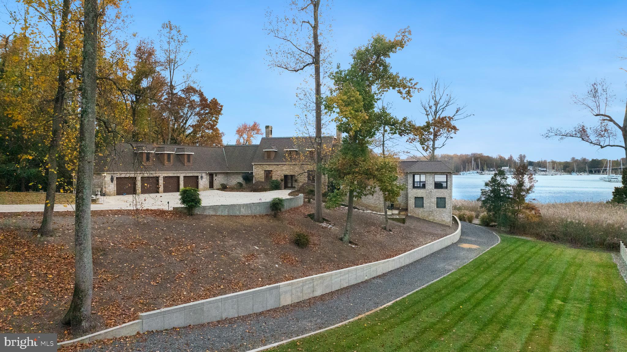 Welcome to your dream home! Nestled on 2.83 pristine acres along the South River in the treelined community of Shadow Point. This exceptional all-brick residence offers breathtaking, unobstructed views and a luxurious pool—perfect for relaxing or entertaining.
The main home features four spacious bedrooms, each with ensuite full baths, ensuring privacy and comfort for all.  The lower level includes a  one bedroom , one bath apartment complete with kitchen, living room and separate entrance.  Almost every room boasts panoramic views of the river, creating a serene backdrop for everyday living. The chef's kitchen is a culinary enthusiast's delight, while the large office and formal dining room provide ample space for both work and gatherings. Unwind in the inviting living room, complete with a cozy wood-burning fireplace.
A standout feature is the beautiful all-brick screened-in porch, complete with a breezeway, wet bar, and bathroom, making it an ideal spot for entertaining or simply enjoying the views. The property also includes a  four-bay garage, equipped with a workshop and additional storage pantry.
For added versatility, a charming carriage house offers 2.5 garage bays and a one-bedroom apartment—perfect for guests or rental income.
The meticulously manicured, fully fenced grounds lead to a newly renovated deep-water dock featuring three slips, a ramp, fishing pier, lifts, bulkhead, and crab deck.
This unique property is a true must-see!
