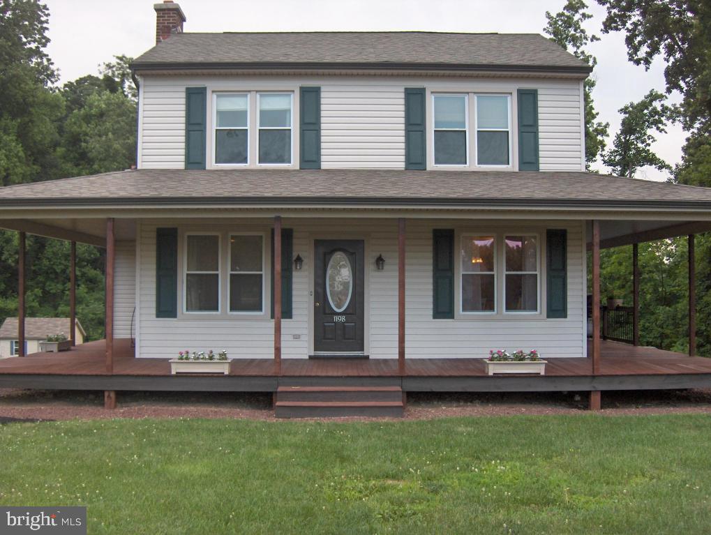 Beautifully remodeled home with 3 bedrooms & 2 baths on 2.6 acres. Mahogany wrap around porch with rear deck looking over expansive lot. Refinished hardwood flrs & new paint throughout. New Carpet. Fireplace in living room. New bathroom. This is a must see home!