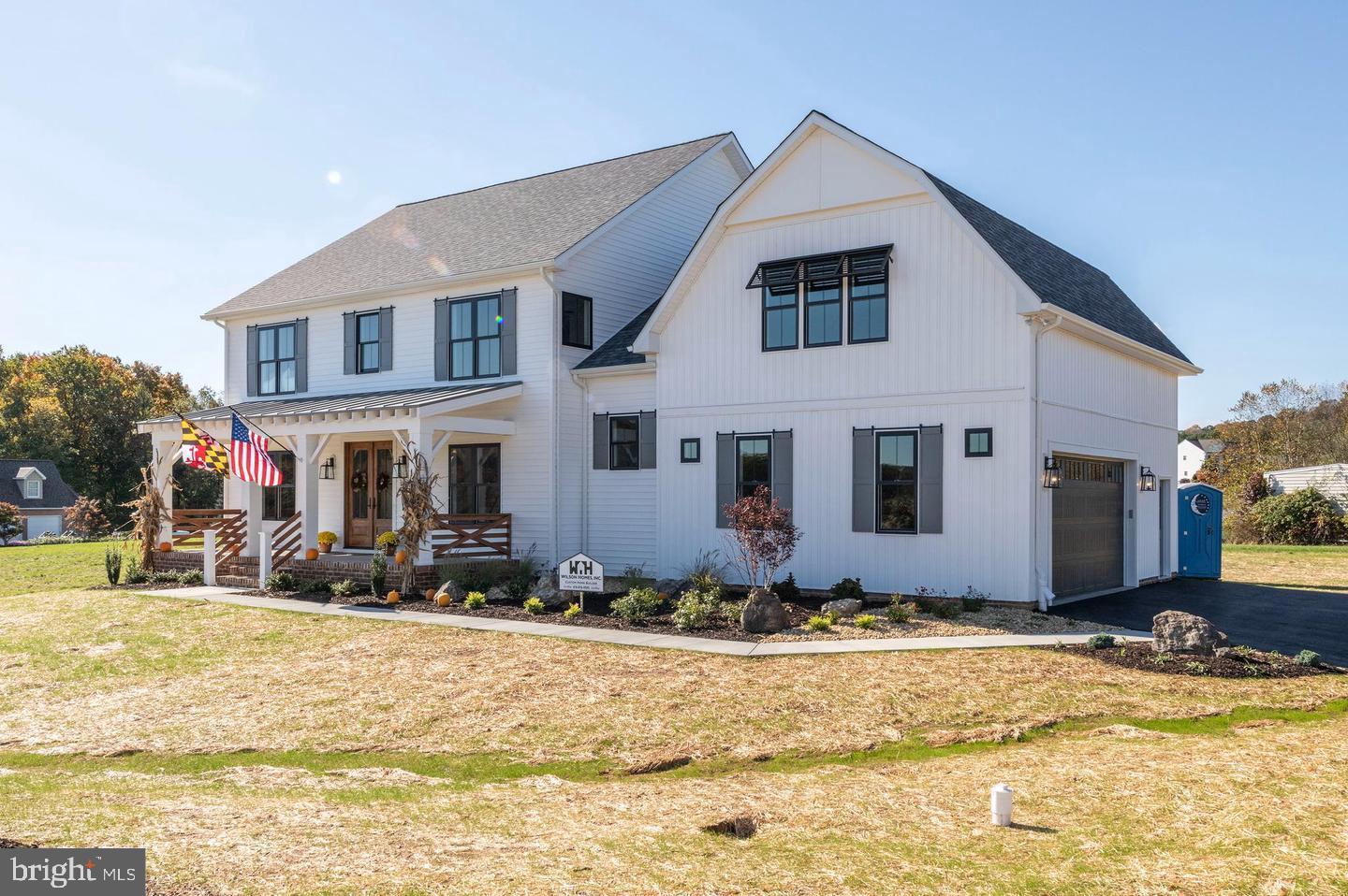 Welcome to the to-be-built home dubbed the 'Industrial Farmhouse' by Wilson Homes Inc., winner of Carroll County's Best! With 3,600 finished square feet, this house has it all! Enter in the double french doors off the large front porch into the stunning main level. The spacious home office greets you to the left. Continue to the kitchen and see the oversized quartz island that sits in the perfect kitchen for entertaining, which is open to the family room with a propane fireplace that includes brick veneer and shiplap. The kitchen includes 42" cabinets, white subway tile backsplash, and stainless steel appliances. Luxury Vinyl Plank throughout the main level and upstairs hall, and carpet in the bedrooms. Dual staircases for convenience, main level washroom with a built-in pet house that makes a great photo op! 4 bedrooms upstairs. The primary bedroom features double walk-in closets, and boasts an optional 3/4 wall for additional privacy and comfort that makes a great reading nook, complete with a mini-fridge. The primary bath has a water closet and stunning tile shower with a glass door. The lower level includes 9' ceilings and can be finished for an additional price, which would make a great entertaining space, complete with an optional full bath. 400 Amp electric service for plenty of room to add on a pool, hot tub, or outdoor lighting feature. On the exterior, you'll find custom-made Bermuda shutters and tasteful landscaping. 2x6' exterior walls and all windows and doors are Andersen 100 series for optimal efficiency and quality. Concealed sprinkler heads, passive radon system, dual-zone Carrier HVAC. Less than 20 minutes from Columbia and 14 minutes from downtown Ellicott City, easily access a variety of shopping, dining, and entertainment options. Convenient commuting location with proximity to MD routes 70, 99, 40, 29, and 32. Expected build time is approximately 6 months from obtaining building permit. Financing options include cash and construction-to-perm loans. See lot listing # MDHW2062200.