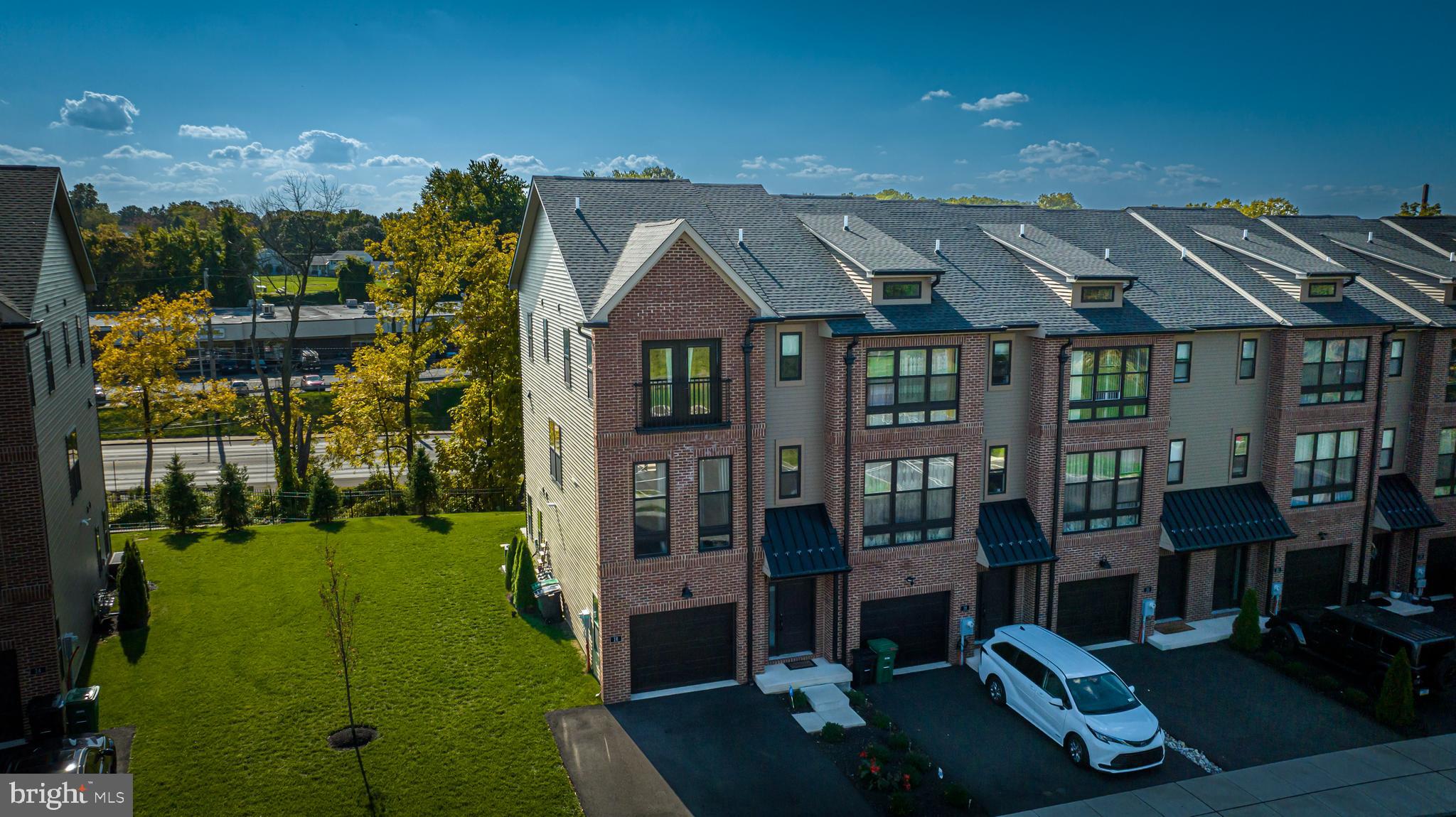 Highly sought after corner model unit now available at The Brickyard. This townhome hits the mark on every key upgrade, as well as some additional upgrades that will surely impress. Main floor features full brick accent wall, open staircase design, fully functional chef kitchen with two-tone soft closing cabinets, and large glass sliding door that leads to upper outside deck. Main floor also features powder room and many windows for plenty of natural sunlight. When entering the home, the lower floor features a recreation room, another powder room for convenience, and a walk-out 20 x 10 EP Henry patio with retaining wall; perfect for entertaining plenty of guests. Also included on the first floor is a complete laundry area, coat and storage closet, and garage access with overhead storage space. Third floor offers 3 bedrooms. Main bedroom includes two fully outfitted closets, Juliet balcony, hanging ceiling light fixtures, and full bath. Upstairs hallway includes linen closet and secondary bathroom. This home is also equipped with full Amazon Alexa voice and application control for lighting, camera systems, door locks, and thermostat settings (optional), which can be remotely controlled anywhere in the world. This home is move-in ready!