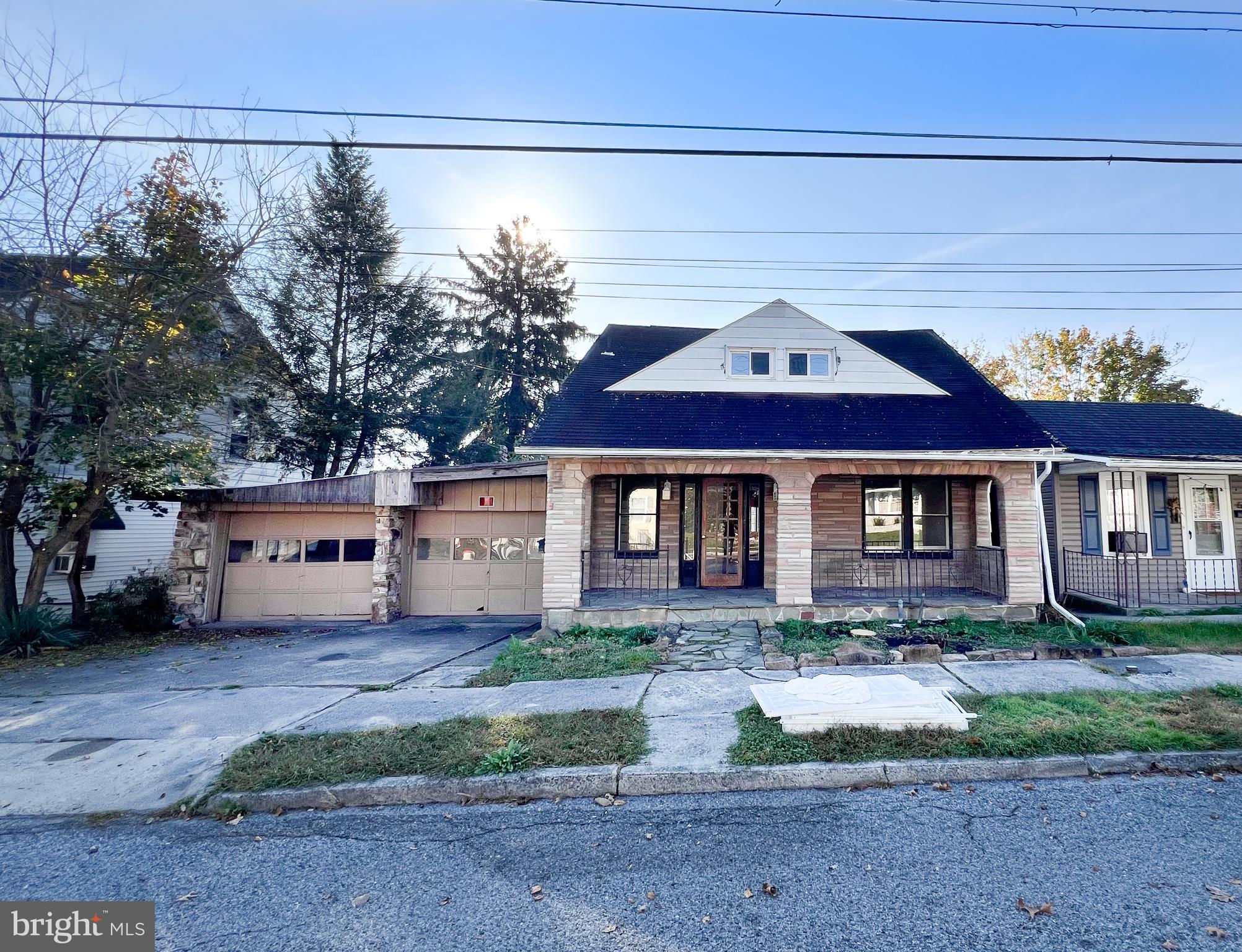 Don't miss this investment opportunity. Main house has warm wood feel, fireplace and large living room. Upstairs are 3 bedrooms and refinished bathroom. Attached is 2 car garage with fireplace. Just past the garden in rear of house is a further 3 car garage; access from alley. Above is a partially remodeled 2 bedroom apartment with fireplace. Brand new metal roof . Apartment in rear is over 1200 sq ft. Garage 848