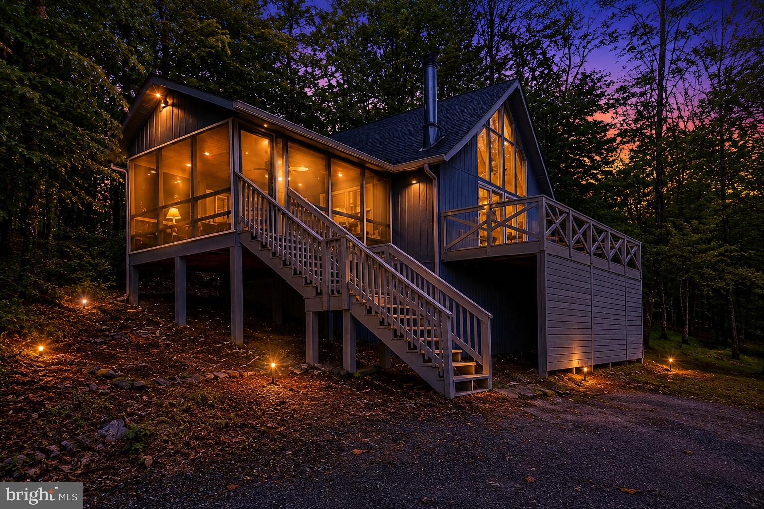 This classic chalet-style home offers 1 bedroom, 1 bath, and a loft overlooking the main living area. The open floor plan combines the kitchen, dining, and living spaces, while a wood-burning fireplace adds warmth and character to the main living area. Oak wood flooring runs throughout the main living spaces, adding warmth and durability to the interior.

Recent improvements include a newer roof and gutters, recently replaced microwave, dishwasher, and stove, updated kitchen and bath fixtures, quartz countertops installed within the last year, and a newer stacked washer and dryer. Brand new carpet in the bedroom and loft, along with brand new vinyl flooring in the kitchen and bath, adds a fresh feel to the interior. Interior paint updates have also been completed in recent years.

Enjoy additional outdoor living space with a large screened porch and open deck. Whether you’re looking for a weekend getaway or full-time residence, this property offers low-maintenance living in The Woods community. Class B transferable membership available.