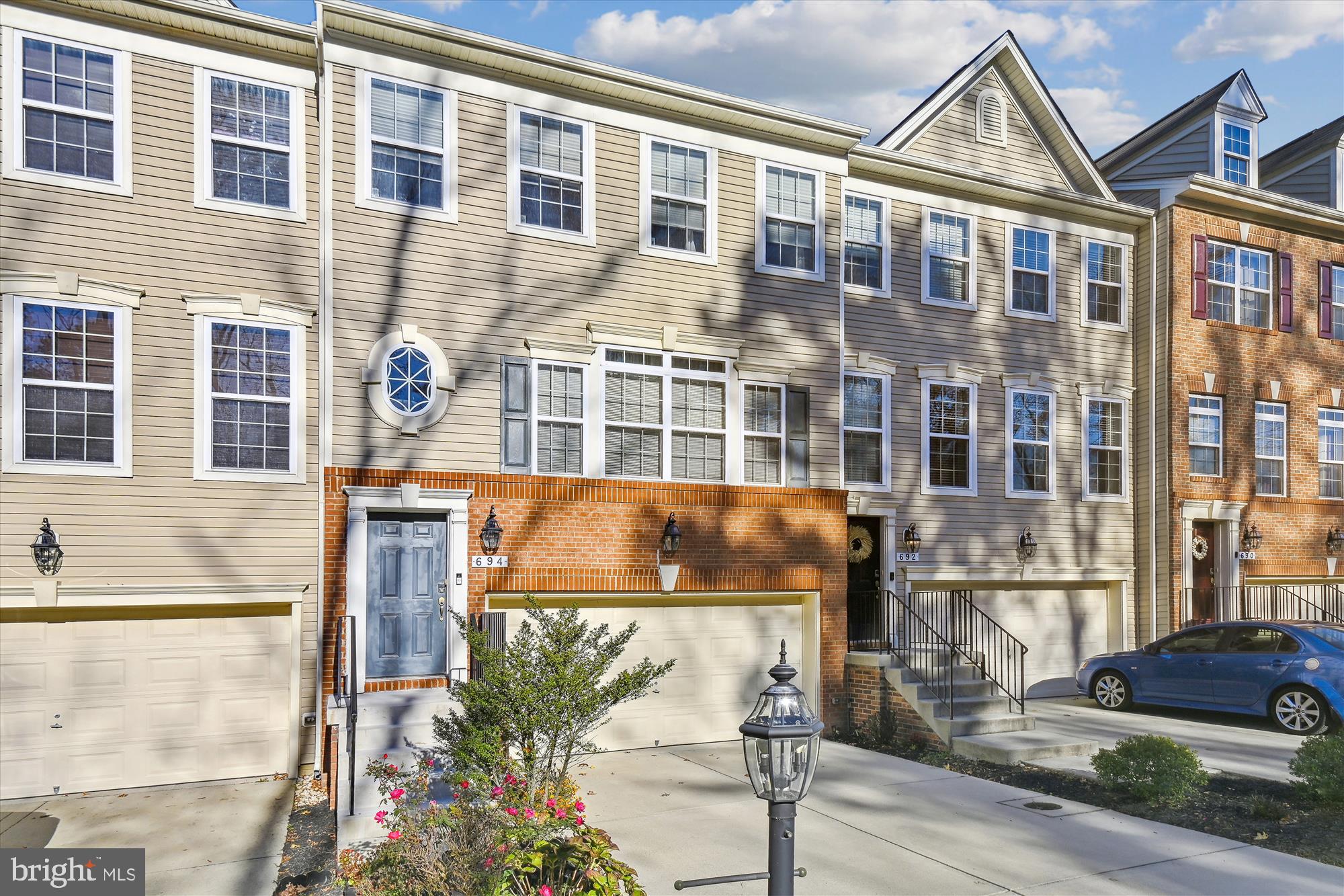 Welcome to 694 Millhouse Drive!  A spacious townhome in the sought after community of Millhouse Creek, a small personable community with its own prestigious identity.  Featuring 3 bedrooms, two full baths and two powder rooms.  Nestled between lush trees, this charming townhome boasts a picturesque wooded landscape at the front and back, offering serene views of nature from every angle.  One of the larger homes with a three level bumpout, full size rear deck and upper level balcony.  The heart of the home is the kitchen, featuring granite counters, 42 inch cabinetry, stainless steel appliances, and a stunning island - the perfect hub for gatherings and culinary adventures. The large living room, dining room, and main level family room share the common element of hardwood floors, creating a cohesive and inviting atmosphere.  Upstairs you'll find the primary bedroom with cathedral ceilings, a large walk-in closet, secondary closet, primary bath with dual sink vanity, soaking tub and private balcony. Two additional bedrooms, hall bath with dual sink vanity and laundry.  The lower level features a spacious family room and secure walk-out slider to patio.  Two car garage and driveway make this home perfect.  One year warranty.  A prime location for commuters to Ft. Meade, DC, Baltimore, and Annapolis. You'll LOVE it!  ***VA Assumable loan for qualified VA buyer***