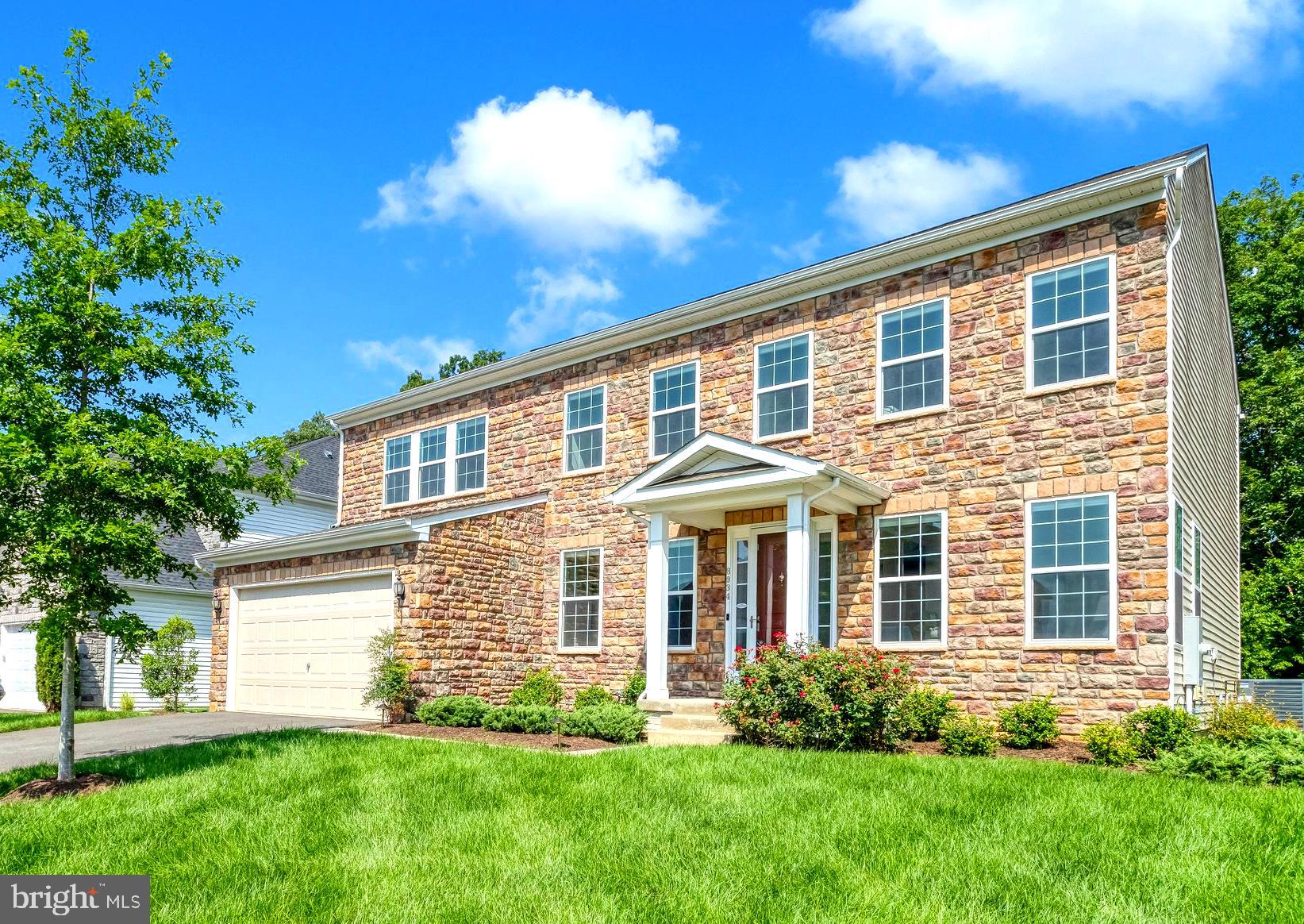 Built in 2022, this wonderful colonial in Lorton’s Laurel Hills Crossing subdivision boasts an impressive 4,572 square feet of total living space. The property stands out immediately with its all-stone front and an array of high-end builder and owner upgrades. From dawn to dusk exterior lights illuminate the front of the house. Inside, the main level features wide-plank luxury vinyl (LVP) flooring and a dramatic two-story family room anchored by a marble-surround fireplace and soaring floor-to-ceiling windows. The formal living room and dining room are elegantly appointed with custom wainscoting and crown molding. At the heart of the home is a gourmet kitchen equipped with GE Cafe appliances with 5 burner stove, a walk-in pantry, and abundant cabinet storage. Conveniently located near the garage, a highly desired mudroom offers extra storage perfect for stocking up on supplies. Walk out the sliding doors to a deck that looks out to trees. 

The upper level serves as a spacious and private retreat, starting with a premier primary suite that features dual walk-in closets, a third accessory closet, a crystal fan chandelier, and spa-style en-suite bath. Three additional bedrooms are located upstairs, sharing two well-appointed full bathrooms equipped with tubs & granite vanities. You'll be delighted to know the laundry room is also on the upper level. A definite asset for most homes.

The fully finished lower level provides an exceptional, versatile footprint to accommodate all of your hobbies. This expansive area features a linear electric fireplace alongside a massive full wet bar complete with white shaker cabinets, a beverage fridge, dishwasher and peninsula bar seating. An extra-large multi-purpose room offers endless flexibility to be used as a game room, art studio, or home office, while an adjacent dedicated space is currently configured as a private home gym.

Beyond the home itself, the location offers an unparalleled lifestyle shaped
by immediate access to the waterfront and an extensive regional park network. Just
minutes away, Occoquan Regional Park sits along the river, providing quick access to
outdoor activities like kayaking and paddle boarding via the aquatic rental center, as
well as on-site batting cages and picnic pavilions. The park is also home to
Brickmakers Café for casual dining and The Riverview Reception Hall, a premier
waterfront venue for major events. Forthose who enjoy an active outdoor lifestyle,
miles of paved and natural walking, running, and biking paths—including

The surrounding Laurel Hill/Lorton communities serve as a hub for sports, recreation, and local culture. Simply by crossing Workhouse Road to you gain access to walking trails, which surround the local cultural landmark Workhouse Arts Center, and is a vibrant 55-acre historic facility hosting artist studios, galleries, and theater spaces, and Liberty Crest, which features historic architecture, open greens, and an outdoor amphitheater for community gatherings. Right next door is the always busy Bunnyman Brewery which is open for breakfast lunch and dinner! Other neighborhood destinations like the Laurel Hill Central Green Park feature playgrounds, picnic areas, a disc golf course, and a dedicated kite-flying field, while the nearby Giles Run Meadow Fairfax County Park offers additional scenic trails and disc golf lines. Horse enthusiasts can utilize the Laurel Hill Equestrian Park, while golfers can enjoy the championship 18-hole course at the Laurel Hill Golf Club. 

Lorton really is a great area for commuters with the VRE located just 3 miles away. Prefer to drive you're minutes away from 95, need to head to west, jump on the Fairfax County parkway.  Also nearby OmniRide offers express commuter bus routes heading straight to the Pentagon, Rosslyn, Ballston, and downtown Washington, D.C. Come see this beautiful home and community.