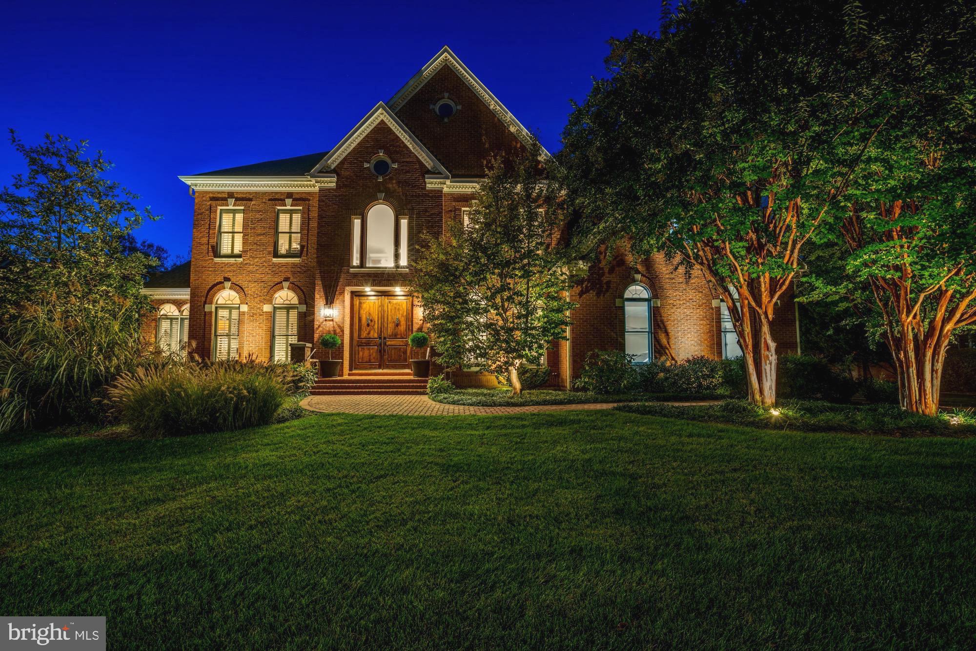 One of the most distinct Tysons Corner homes with an extraordinary detached 1 bedroom guest house, substantial 6 foot estate brick wall encompassing the rear grounds and a motor court with parking for as many as 10 cars. The primary residence is currently furnished as 6 bedrooms on 3 floors across nearly 8,000 square feet.  Just beyond the brand new entry doors, the main level features a double height foyer and tiered Murano chandelier which opens to formal living and dining rooms. The dramatic ceiling height continues into the great room with a dazzling stone fireplace, additional staircase, exposed second floor walkway and open floor plan. The newly remodeled gourmet kitchen is right out of a design magazine with a serene color palate of white cabinetry, subway tile and gleaming Mont Blanc Brazilian quartzite countertops. It offers a suite of Subzero appliances including a French door refrigerator and separate Subzero island beverage drawers, Wolf cooktop and convection oven with separate Wolf warming drawer and 2 Bosch dishwashers. The main level is also home to a large light filled sunroom, bedroom or study with adjacent full bathroom, mud room, laundry room and direct access to a 2 car garage bay. The second level features an oversized primary bedroom suite with a sprawling spa bathroom, heated floors and custom tile work. There are three additional bedrooms on this floor, 2 more full bathrooms and a second full size washer and dryer pairing. All of the windows are outfitted with custom plantation shutters which allow light and privacy control.  The walk out lower level is all about entertaining. It features a smart technology home theater, additional 1,900  square foot living space, full bathroom and a separate room furnished as a 6th main residence bedroom. The manicured rear grounds are highlighted by an impressive brick patio with a built in grill, decorative iron fencing and the handsome 6 foot brick privacy wall. The detached guest house is approximately 1,200 square feet with soaring loft ceilings, kitchen sized wet bar, 1 bedroom, full bathroom, laundry room and direct access to an additional garage bay. In summary, this meticulously maintained residence which received new roofing in 2020, can  be used as seven bedrooms or configured to suit your needs. The close proximity to upscale Tysons Corner amenities and major communing arteries such as Route 7, Interstate 66 and the Capital Beltway, creates a rare and special balance of refined luxury living with unparalleled convenience. Showings by appointment. Video is uploaded.