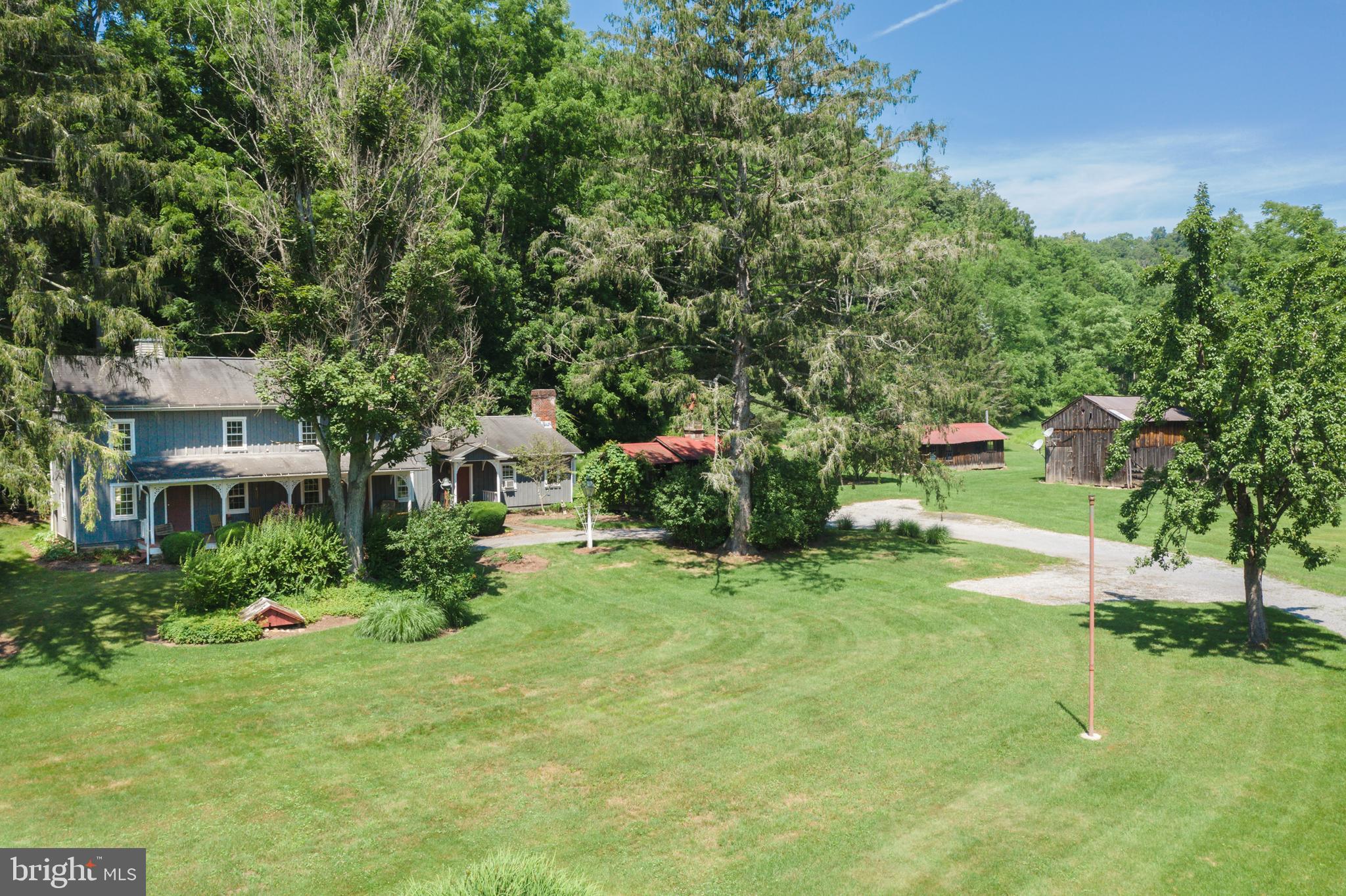 Nestled on 18 private acres in the quiet countryside of Petersburg, this 3‑bedroom, 3-bath homestead offers the perfect blend of rustic charm, open space and endless potential. This single‑family home provides a comfortable footprint for full‑time living, a rural retreat, o r a hunting and fishing recreation getaway. With Standing Stone stream frontage and surrounded by rolling land, the property delivers the privacy and tranquility central Pennsylvania is known for. The home has special features including a hand painted mural of McAleys Fort before development, 2 pot belly stoves, cookstove, wo o d stove, fireplace, wide plank wood floors and the most inviting front porch to sit and relax. Whether you envision gardening, hobby farming, ATV trails, or simply enjoying wide‑open acreage, this property gives you room to create the lifestyle you want. Located in Huntingdon County, you’re just a short drive to State College, Raystown Lake, and outdoor recreation areas—ideal for buyers seeking space without sacrificing access to amenities.