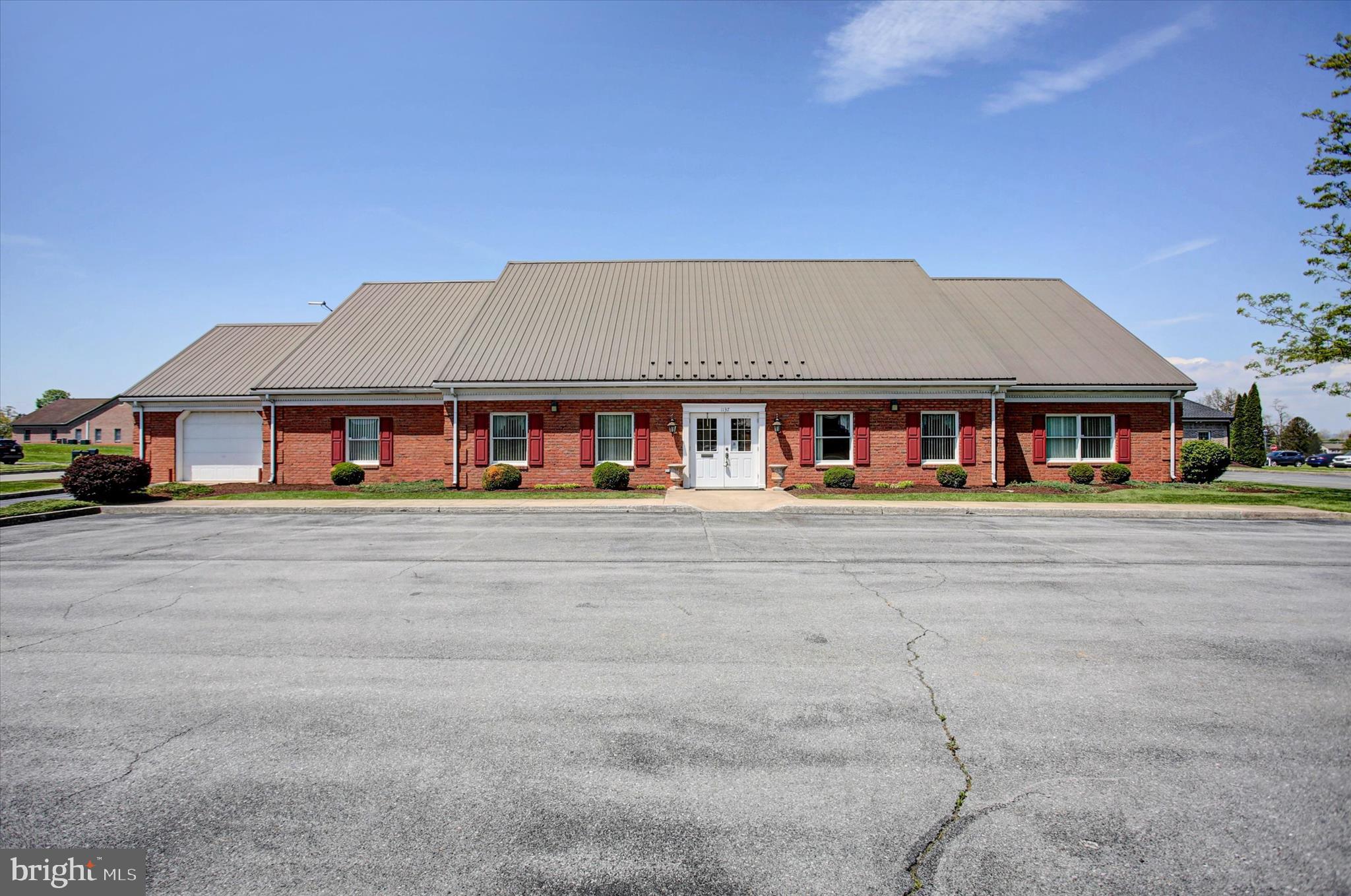 LOCATION! SPACE! OPPORTUNITY! This prime commercial property offers 4,390 square feet of flexible office space along with an additional 600 square feet of garage or storage area, making it ideal for a variety of business uses. The interior is currently configured with over 10 private offices, two spacious conference rooms, a kitchen/breakroom area, and a welcoming front foyer/reception space. With 35+ on-site parking spaces, accessibility for employees and clients is never a concern. The layout provides excellent functionality as-is, while still offering the opportunity to easily reconfigure or customize to fit your specific business needs. Conveniently located near major highways, restaurants, and other local businesses, this property delivers both visibility and convenience—perfect for taking your business to the next level.