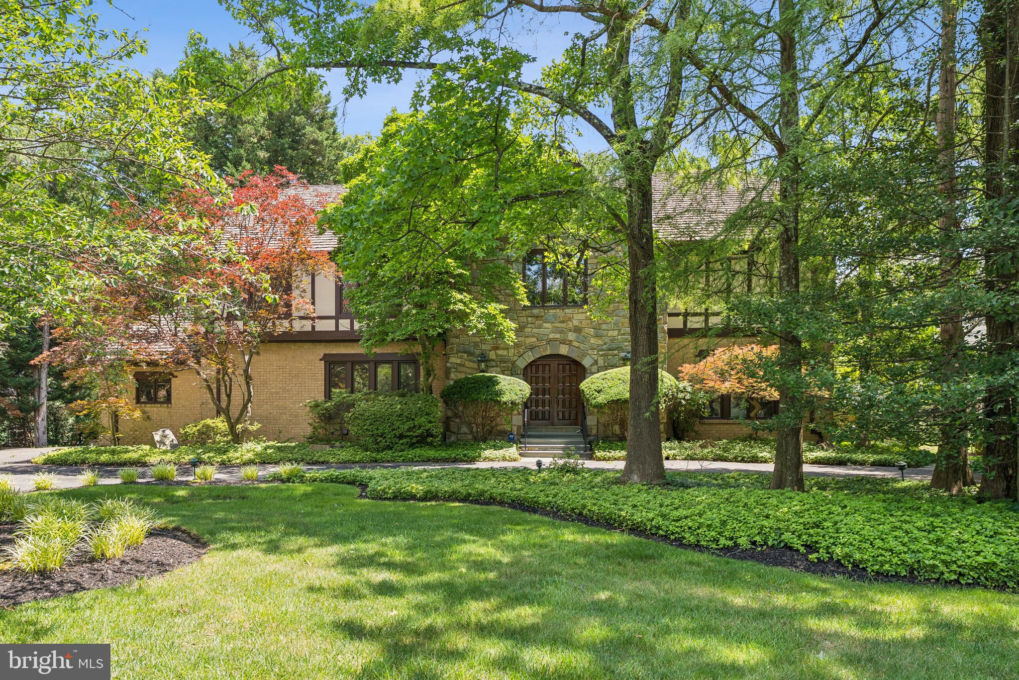 NEW ON MARKET! ANY OFFERS DUE BY 12 PM NOON on TUESDAY JUNE 24th. 
Prime location in Potomac Village! Welcome to this elegant, freshly painted custom-built brick and stone Tudor, situated on 2/3 acre on a quiet street, just a short walk to Potomac Village. Enter the spacious, two-story foyer featuring exquisite woodwork and staircase. The library/home office with built-in’s is located across from the expansive living and dining rooms, which can comfortably accommodate 12 or more dinner guests, providing an ideal setting for entertaining. A sunlit family room with a stone fireplace and built-ins opens to a large low-maintenance deck.  The renovated kitchen, equipped with high-quality cabinets, stainless steel appliances, granite countertops, and a large island, adjoins the generous four-season glass/screened porch with skylights. This porch opens to a circular brick and flagstone patio in the rear yard.  A formal powder room and laundry room complete the main floor.
The upper level features a large primary bedroom suite with an adjoining sitting room, three walk-in closets, and a spacious bath, along with four additional generously-sized bedrooms and two more full baths. Hardwood floors are present throughout both the main and upper levels. The walk-out lower level comprises a large recreation room, built-in wet bar, wine storage, two bedrooms/bonus rooms, and a full bath, as well as additional storage. Sliding doors provide access to a second ground-level flagstone patio, outdoor kitchen, and gazebo.
Adding to the charm, the community itself offers an exceptional quality of life, with highly rated schools just a short distance away. Potomac Village offers many conveniences: grocery stores, gourmet shops, diverse dining options (restaurants, coffee shop, pizza parlor, ice cream shop), a hardware store, beauty salons, library, banks, post office, professional services, and a bus to Friendship Heights Metro. Welcome home!