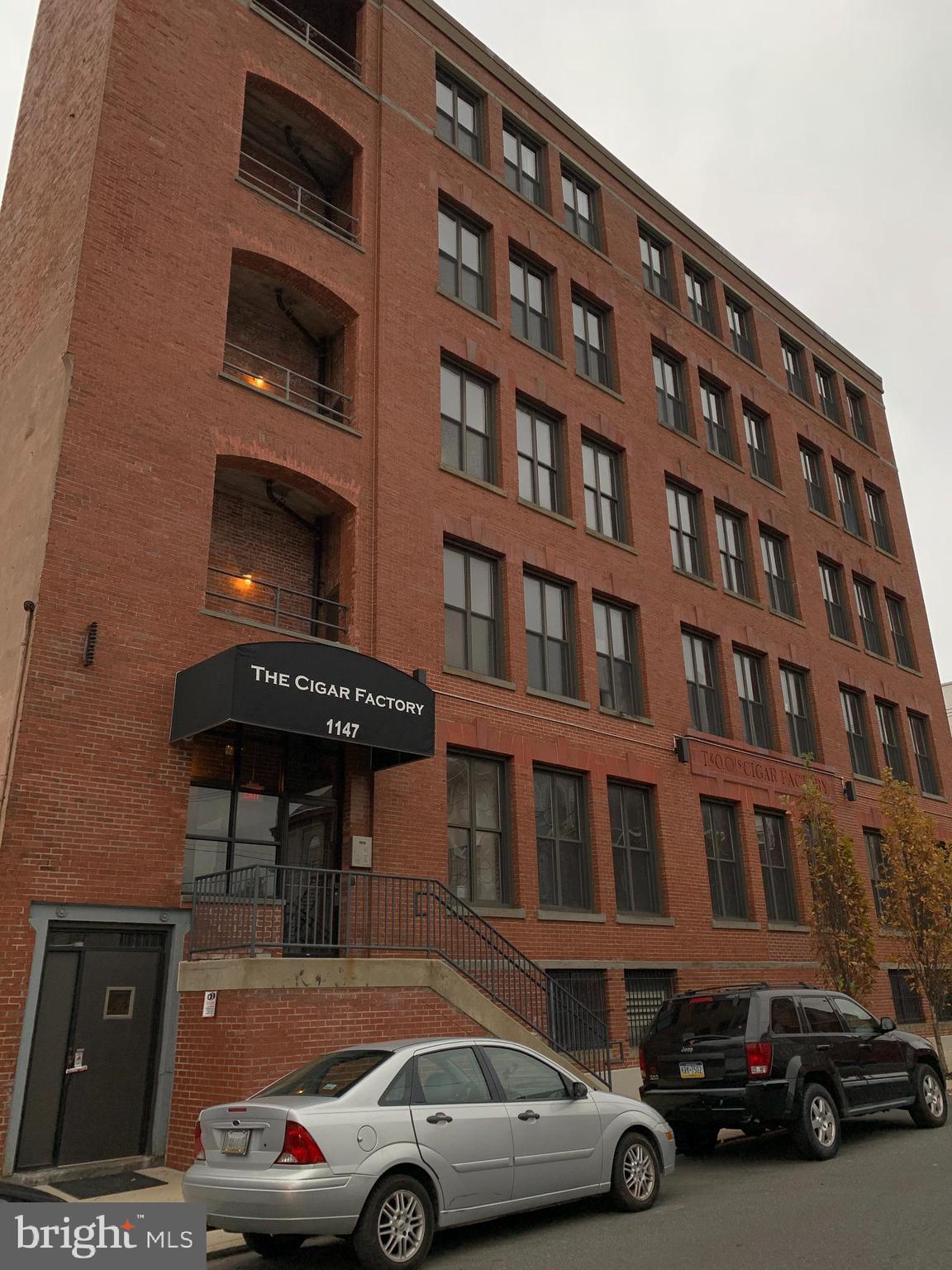 Fantastic opportunity to live in the completely renovated Cigar Factory in Northern Liberties and have parking.  Just minutes from Liberties Walk, Fishtown, restaurants, bars, shops, public transportation (Market-Frankford line) and easy access to I-95.   This 1,500 square foot, 2 bedroom ( 1 small),  2 full bathroom condo has 14 foot ceilings, 8 foot tall windows , concrete floors and original 1890 exposed brick throughout. Kitchen has top of the line appliances, granite countertops and tons of cabinet space. The master bedroom is fully surrounded by exposed brick. The master bathroom has his and her sinks, a jacuzzi tub and walk-in shower. In addition to the master bedroom, there is an additional space noted as a bedroom, that is currently being used as a huge walk in closet that can also be used as an in home office, work out space, or even a wine closet. Off of the open concept living area, there is an additional walk in closet. Unit also includes central air/heating, coat closet, washer/dryer included (in second bathroom), single dedicated parking space in bottom floor garage, additional storage area at rear of parking space,elevator access to all floors, call box entry.  The indoor parking space can fit an over-sized vehicle and is a very rare amenity that you don't usually find in Northern Liberties. It is even heated for those cold winter mornings. Never worry about parking again with elevator acess to your vehicle!  No smoking. Pets are allowed. First and last months, as well as one month's security deposit required for move in.  Walk Score 98, bike score 83.  There is also 14,000 square feet of common patio space for the community. Available May 1st.