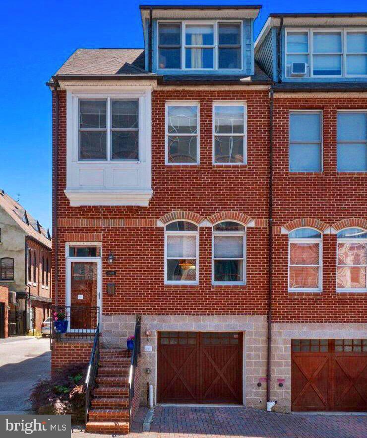 This beautiful treasure in Canton, featured in the Baltimore Sun's "Dream Home" feature, is located on a quiet one way street that dead ends into Canton Square. Walking distance to fine dining and hip stores in Canton, Fells Point and The Shops at Canton Crossing. You're just a short scooter ride from downtown, Camden Yards and M&T Bank Stadium, Johns Hopkins Hospital downtown and Bayview Medical Center. This is an arts and craft style home, professionally decorated with a modern edge, featuring a solid mahogany front door and a wood garage door. The rear of the home features a private fenced in grass back yard with two terraces! Three outdoor spaces! One on the main floor and another on the third floor with city views, views of the Natty Boh neon sign, and water views of the harbor. The main floor features gorgeous arts and craft style molding, rich Brazillian cherry floors in the living room and dining room, dazzling designer lighting, and a gas fireplace surrounded by custom blueish green tiles and a generous mantle. Custom silk window treatments adorn the windows accompanied by honeycomb blinds. The gourmet kitchen features a two level island with seating for two stools, ceramic tiles, 42” cherry cabinetry with crown molding, a custom glass tile back splash, stainless steel double bowl sink and a garbage disposal. The second floor has a master bedroom and master bath with a jetted tub, 1 additional bedroom, a full bath, lovely office and a laundry room with stackable washer and dryer. The third floor has a gorgeous guest suite with a wet bar, full bathroom and a lovely terrace with beautiful views of the city. The heated tandem garage on the basement level has room for two cars, and storage. It includes a stocked work bench and shelving There is also a room on this level with rough ins for a washer and dryer. This is city living at its best and being so close to 895 and 95, Patterson Park and city marinas.