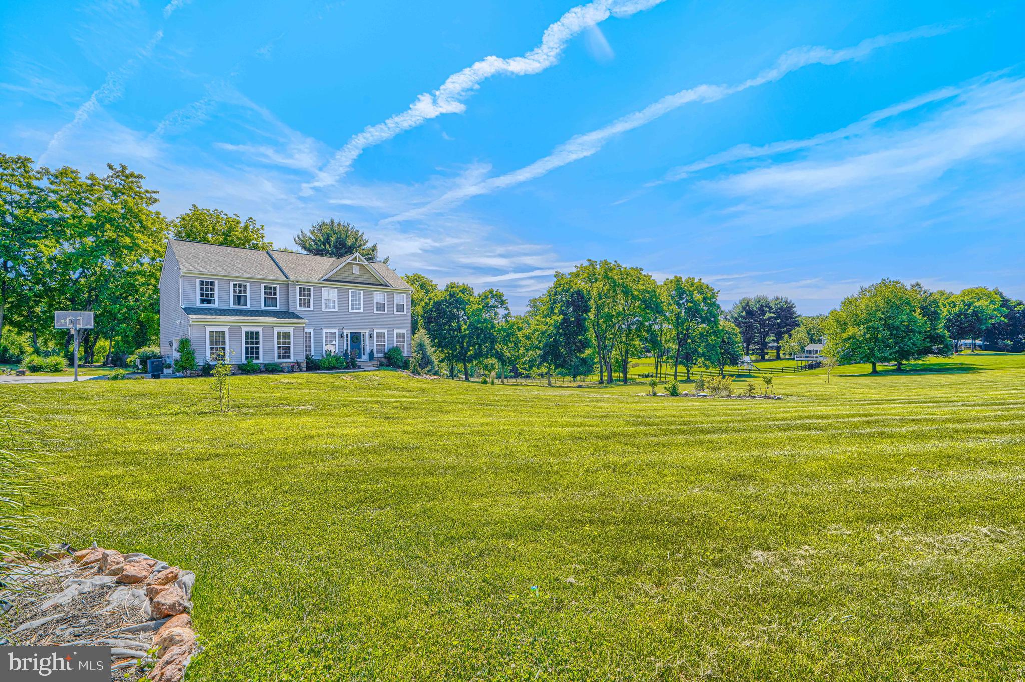 Welcome to 3825 Jarrettsville Pike, nestled in the rolling and lush hills of Harford Country Horse Country.  This is a "best of both worlds opportunity" offering the charm of a colonial estate and the maintenance free life-style of a nearly new home.  Inspiration abounds with excellent indoor entertaining space and breezy outdoor greenery.  Key features include:  a kitchen with an island, and a bar area for casual dining; table space for a group dinner by the deck; a cozy living room with a gas fireplace; a separate dining area that adds a touch of luxury, and a den or study for a quiet get away. The upper primary suite is a spa like retreat. A sunken tub, a large walk-in shower and 2 oversized walk-in closets, what more could you want? The bedroom area itself has vaulted ceilings and gorgeous natural light. Three additional bedrooms and another bath complete the lovely top level. Still looking for more space? The lower level is excellent for overflow, there is a large family room with level walkout to the side yard, another bedroom, a full bath and work out room. Unfinished storage area is also available. All of these wonderful features are located within 25-30 minutes of Towson and 10 minutes to local shopping and restaurants. 3825 Jarrettsville Pike is your destination!