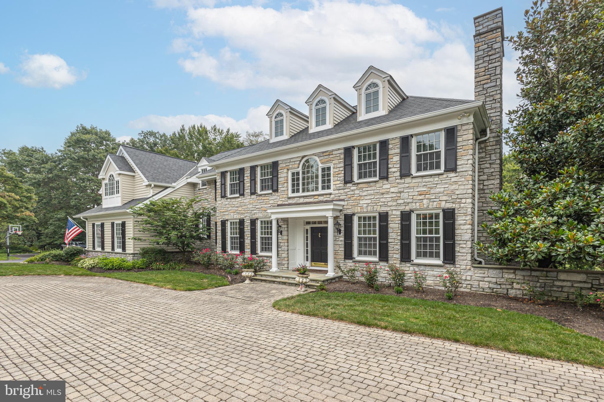 Discover the Classic Elegance in Exclusive Ely Farm! Just beyond the expansive paver courtyard in the prestigious Ely Farm enclave, this stunning center hall estate offers timeless architecture, luxurious finishes, and exceptional indoor/outdoor living. Set on a private, professionally landscaped lot surrounded by mature trees, this home features incredible outdoor spaces ideal for entertaining or relaxing in total privacy. Inside, you'll find elegant wood  flooring, transom windows, an open staircase with a dramatic wall of windows, three fireplaces, and custom lighting throughout. The designer kitchen is a chef’s dream—featuring a large center island with seating, commercial-grade appliances, and expansive prep areas—opening to a bright Morning Room with tray ceiling. The spacious Family Room offers a coffered ceiling, built-in surround sound, and access to a private patio. A sun-drenched Study with custom built-ins and walls of windows provides the perfect home office. Upstairs, discover four generous en suite bedrooms and four-zone heating and cooling for ultimate comfort. The luxurious Primary Suite is a true retreat—complete with a Sitting Room, 3 Walk in closets, vaulted ceilings, and a wall of windows. The suite includes marble baths, an oversized shower with triple shower heads, and radiant heat flooring. The fully finished Lower Level is designed for entertaining, with a full catering kitchen (including dishwasher), Media Room with fireplace, guest bedroom, full bath, and a spectacular wine cellar—all with walk-out access to a second private patio.  Recent updates, super convenience to Princeton & I 295, and award winning Council Rock Schools complete the offering. This exceptional home combines classic elegance with modern luxury—truly a rare find in Ely Farm.