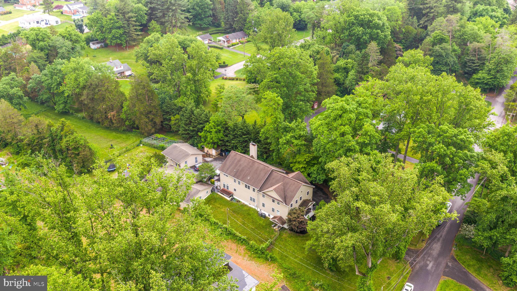 You WILL NOT want to miss this unique and rare opportunity. Sellers offering $20,000 closing cost assistance. This expansive estate offers over 8,000 sq ft of finished living space in total, as well as a guest dwelling/house, and oversized detached garage that could fit up to 8 cars. This home has incredible attention to detail throughout, boasting Brazilian cherry hardwood flooring on all levels,  9ft+ ceilings throughout, as well as a wood burning fireplace on each level. The kitchen is a chef's dream, with excess cabinetry, counter space and an ample sized pantry. The owner's suite offers a juliet balcony, sitting room, enormous walk in closet and an open-concept en suite bathroom. This entire property sets on over 1.5 acres, with plenty of space for entertaining, gardening etc. The basement is set up as an in-law suite, with it's own bedroom and bathroom and same with the guest dwelling.  Extremely rare to find this kind of set up and square footage for the area! Total bedroom/bathroom count does not include guest dwelling, as well as a couple other rooms throughout that could easily be used as bedrooms. Owner financing could be available, contact listing agent for more info. Book your showing today!