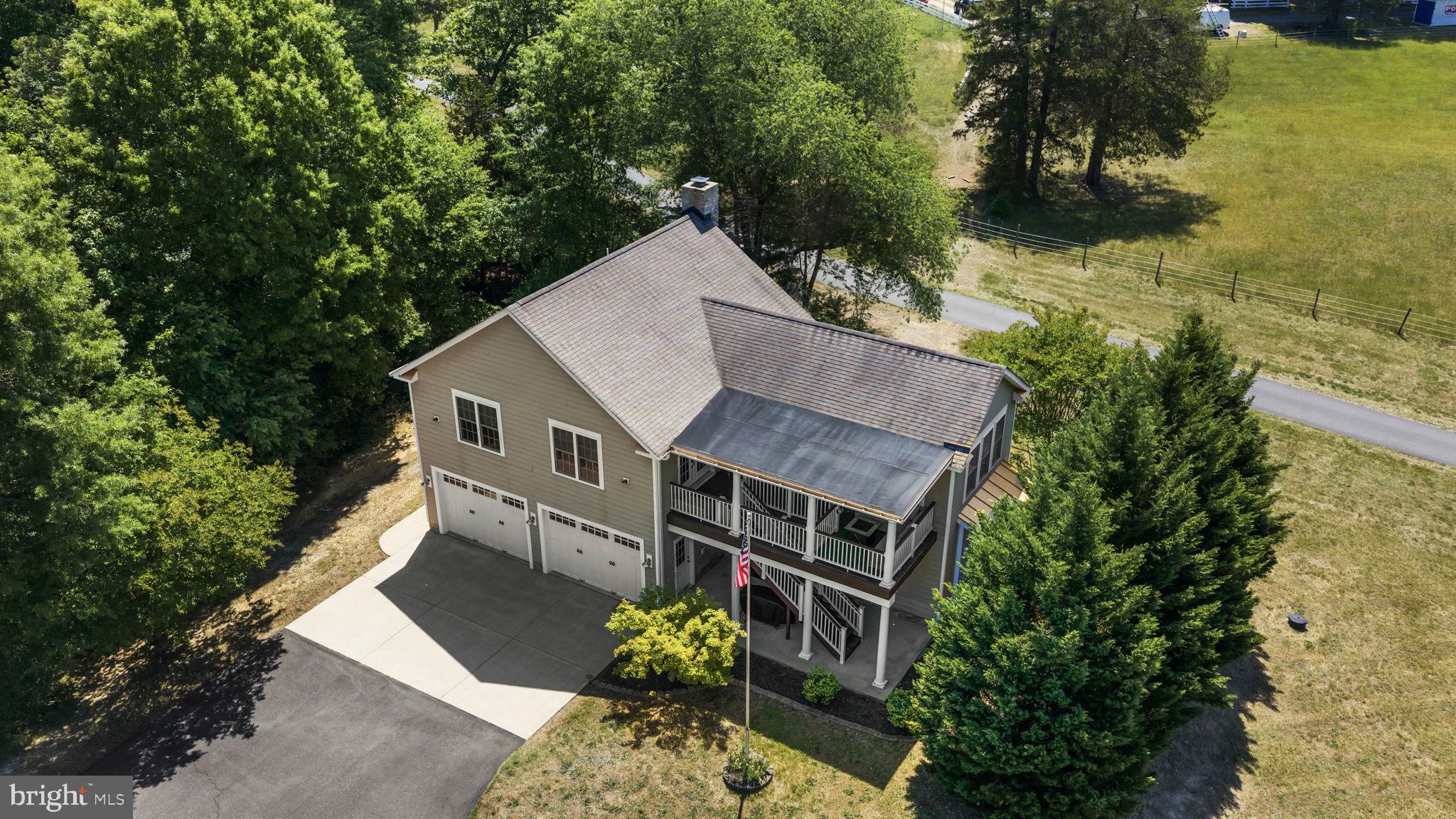 Located on over 3 private acres with NO HOA in a highly desirable South Stafford location, this unique carriage house property offers flexibility, functionality, and endless potential. The upper-level residence features 2 bedrooms, 1 full bath, and approximately 1,284 square feet of thoughtfully designed living space with an open-concept layout and beautiful Brazilian Cherry hardwood flooring throughout. Recent improvements include a new water heater installed in October 2023 and a full upstairs American Standard HVAC system installed in December 2024. Not to mention, a whole home generator providing peace of mind for the next owner. On the ground level, you’ll find an oversized two-bay garage along with a separately accessed living area offering an additional 314 square feet complete with a potential 3rd bedroom and full bath suite. Ideal for multigenerational living, guest accommodations, a private home office, long-term rental income, or short-term rental potential, this versatile space provides valuable flexibility for today’s buyers. Please note: the staircase connecting the upper and lower levels is located outside the home, allowing for added privacy between the living spaces. There is no interior staircase. An additional storage shed located at the front of the property provide the perfect place to store lawn equipment, tools, and outdoor essentials, helping keep the oversized garage bays open for vehicles, recreational equipment, hobbies, or additional storage needs. Enjoy the peace and privacy of country living while still being conveniently located minutes from shopping, dining, commuter routes, and downtown Fredericksburg.