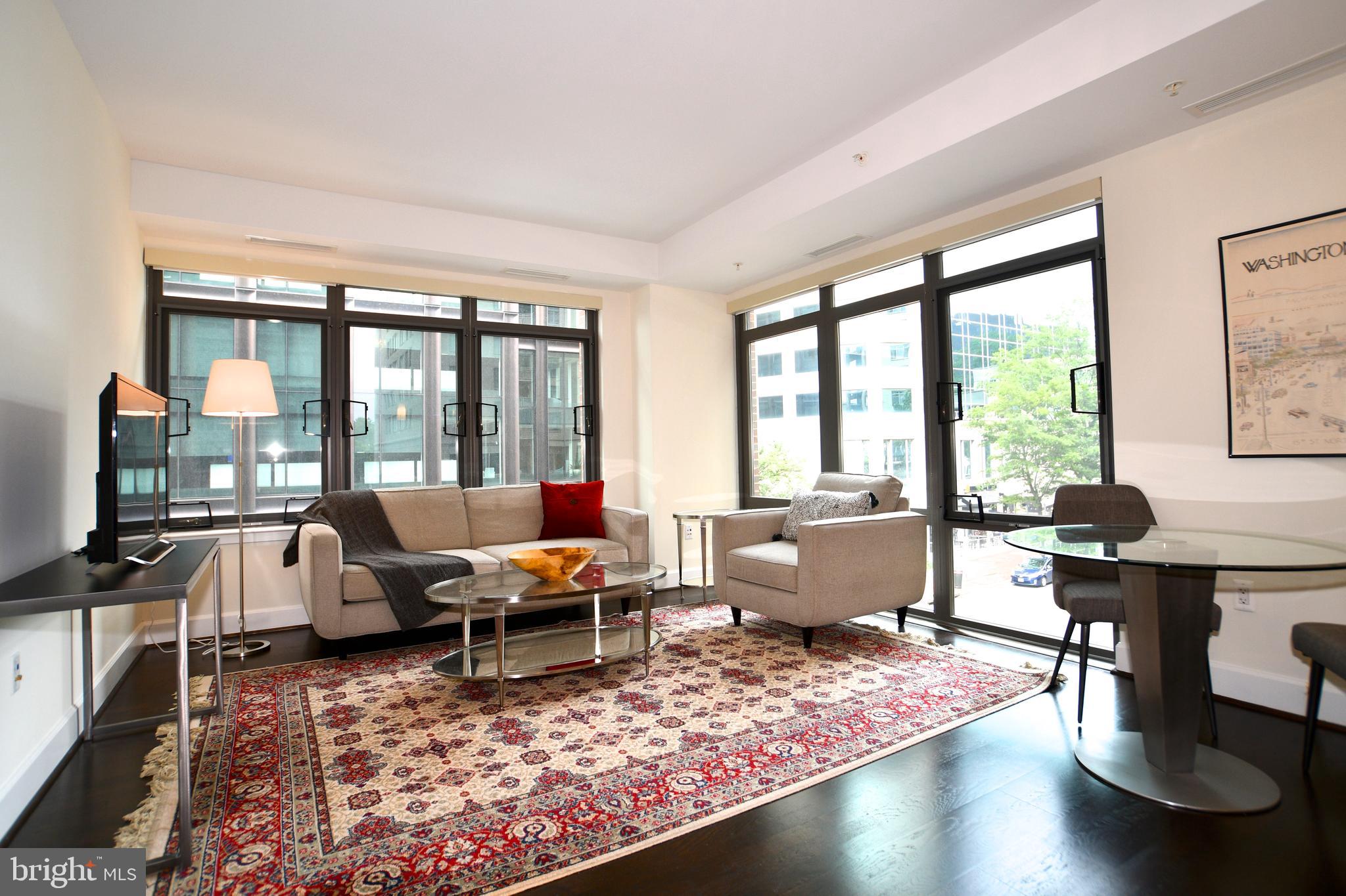 AMAZING NEW PRICE makes this the best value in Bethesda in a newer luxury condo building with wonderful amenities! The Darcy is a 5-year old boutique luxury condo located in the center of downtown Bethesda. This sophisticated, light-filled corner unit features an owners suite, a second bedroom and bath, open kitchen-living space layout with custom cabinetry, high end appliances, granite countertops, hardwood floors and 9' ceilings. The 1,075 square foot apartment has a spacious feel, with a nice entryway and separation of the bedrooms and bathrooms. One garage parking spot comes with the apartment, a storage unit also conveys. Settlement flexible.  Amenities in the SK & I Architectural Group-designed building include: 24/7 concierge, resident lounge, secure parking, rooftop deck, fitness and business centers, and guest suites. One reserved secure garage parking space and storage unit comes with the unit. This is an elegant building in a superb location convenient to great restaurants, shopping, METRO,  theaters, and the Crescent Trail for hiking and biking.