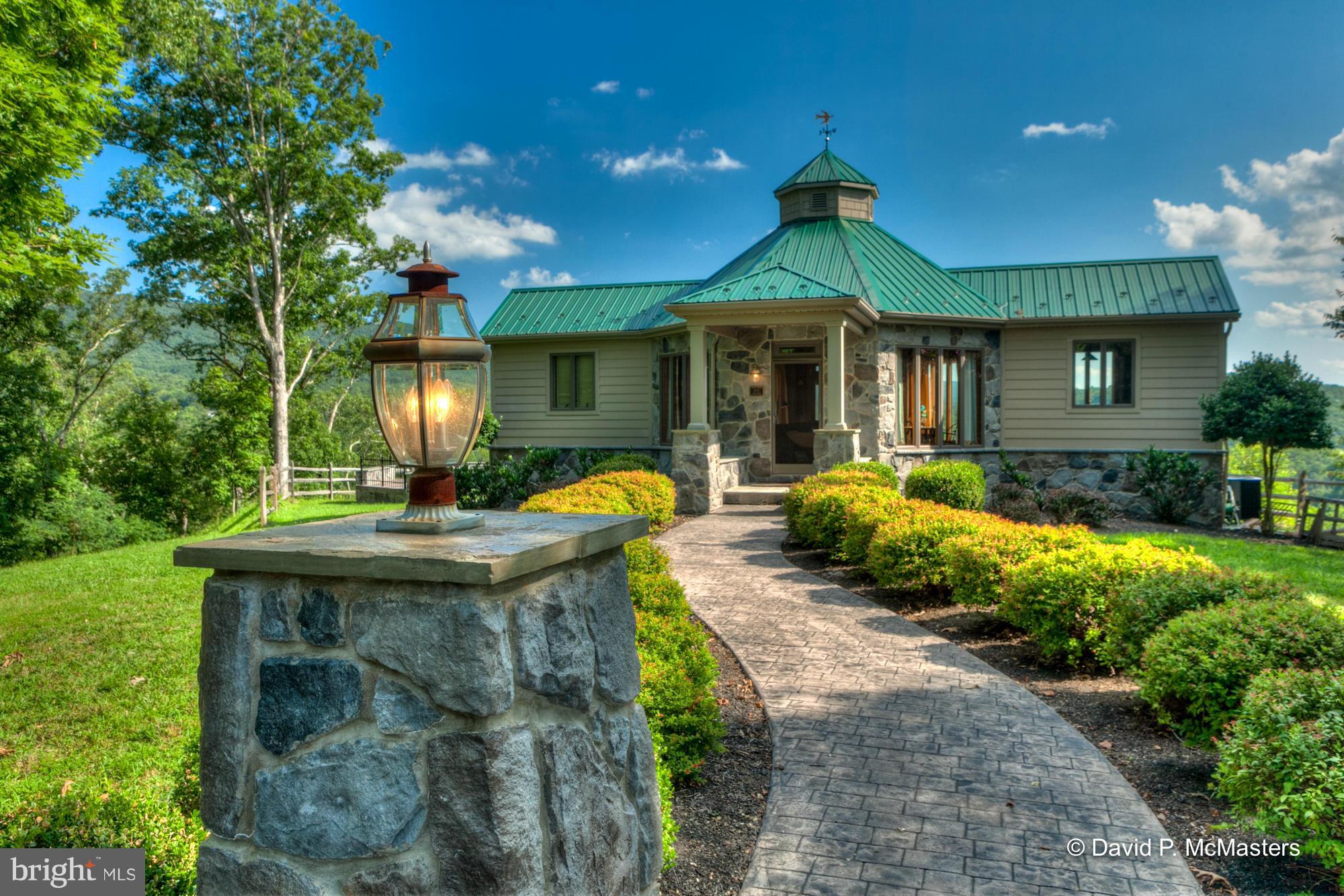 FABULOUS  overlook cottage on three lots total 19+ acres. Estate setting. Add'l home site w/ well and septic. Highest quality construction.  Great retreat, studio or office. Great for a writer or a thinker. Very private. GORGEOUS meadow/mountain views. Stream on prop. Vaulted central room/BR, gourmet kitchen FB. Big slate deck w/big fire pit.  Beautiful landscaping. Gated entry.  5 mi to I-68/70.