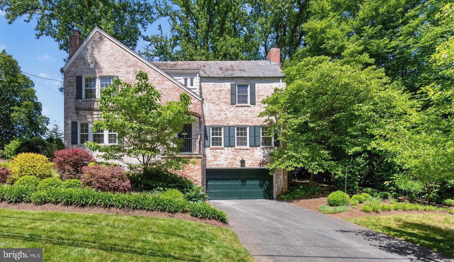 Welcome to a whimsical, magical home on the hill — the kind of home you may never want to leave.
Set on a premium wide lot with lovely gardens, stone patios, winding walkways, and exceptional privacy, this enchanting whitewashed brick Colonial perfectly blends timeless character with thoughtful modern updates. Distinguished by its elegant copper gutters and timeless slate roof, the home exudes charm, quality, and craftsmanship rarely found today.

Fully refreshed and refined from top to bottom, this special residence offers beautiful hardwood flooring, luxurious marble bathrooms, two beautifully revamped marble fireplaces, and inviting spaces designed for both everyday living and effortless entertaining.

At the heart of the home is the beautifully renovated chef's kitchen, featuring elegant quartz countertops, abundant cabinetry, and a stunning quartz peninsula designed for both everyday living and entertaining. The spacious peninsula comfortably accommodates barstool seating, creating the perfect gathering place for morning coffee, casual family meals, homework sessions, or simply enjoying conversation while preparing dinner. Thoughtfully designed for modern living, the peninsula also functions beautifully as an eat-in kitchen and entertaining hub, offering generous space for serving food buffet-style during holidays, celebrations, and family gatherings. Whether hosting guests or enjoying a quiet evening at home, this inviting space encourages connection and creates the warm, welcoming atmosphere that makes a house truly feel like home.

Original details, including the classic railing, abundant built-ins, and architectural character throughout, add warmth and authenticity, while tasteful renovations bring modern comfort and style. The sun-drenched sunroom, surrounded by new windows, creates a peaceful retreat where natural light pours in and the beauty of the outdoors can be enjoyed year-round.

A rare first-floor bedroom with its own fireplace offers incredible flexibility and can serve as a guest suite, private home office, reading room, library, or cozy retreat. Every room has been thoughtfully designed to provide both comfort and function while maintaining the home's unique character and charm.

Outside, the expansive grounds provide the perfect setting for entertaining, gardening, relaxing, or simply enjoying the peaceful surroundings. The stone patios and walkways create inviting outdoor living spaces that feel like a private sanctuary. A spacious two-car garage provides added convenience and storage.

Rarely does a property offer such a compelling combination of charm, craftsmanship, privacy, and future potential. Beyond its stunning renovations, timeless architectural details, slate roof, copper gutters, and magical setting, the expansive lot provides a unique opportunity for future additions or expansion if desired. Whether enjoyed exactly as it is today or thoughtfully enhanced over time, this extraordinary residence offers the flexibility to create a true forever home while preserving the character, beauty, and warmth that make it so special.

Major Mechanical Upgrades include: Complete HVAC system replacement (November 2024) includes humidifier, dehumidifier, new compressor — backed by a **transferable warranty** (10-year parts / 5-year labor) through GAC Services, plus prepaid bi-annual maintenance coverage through November 2029. System also features **Aeroseal duct insulation** for enhanced efficiency. 

House is Conveniently located close to Washington, DC, Metro access, shopping, dining, and major commuter routes, this is more than a home—it is a lifestyle. A rare offering where timeless elegance, modern comfort, and endless possibilities come together in one remarkable property. Once you arrive, you may never want to leave.