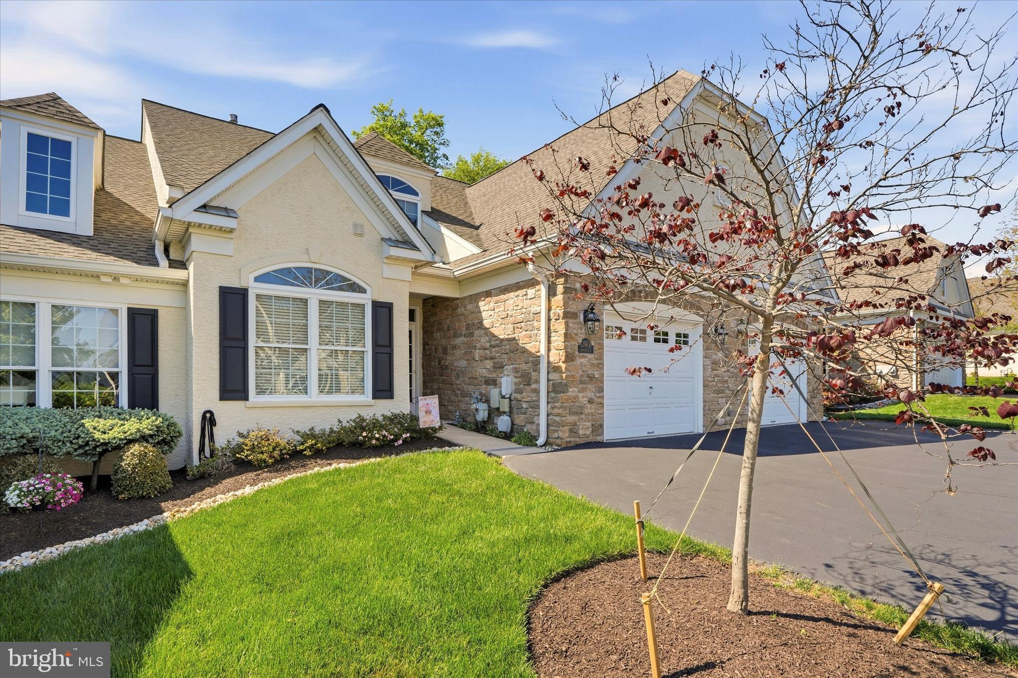 Rarely available in one of Harrington Village’s most desirable settings, this beautifully maintained carriage home offers the perfect blend of privacy, space, and effortless 55+ living. Backing to serene wooded open space and a scenic walking trail, this move-in ready home combines the ease of main-floor living with generous guest and entertaining space in a vibrant, amenity-filled community.

This move-in ready home offers over 2,100 square feet of bright, inviting living space with 3 bedrooms, 3 full baths, soaring cathedral ceilings, and an open, flowing floor plan designed for easy everyday living and entertaining.

From the moment you enter, you’ll appreciate how exceptionally well cared for this home has been. Sunlight fills the spacious living and dining areas, while the adjoining sunroom creates the perfect place to relax and enjoy peaceful wooded views year-round.

The spacious eat-in kitchen features gas cooking, abundant cabinetry, pantry space, a butler’s pantry, and brand-new kitchen appliances installed in January 2026—offering both style and functionality for today’s buyer.

The highly desirable main-level primary suite provides comfort and convenience with a large walk-in closet and private bath. A second main-floor bedroom and full bath are ideal for guests, while the finished upper-level loft with its own full bath offers flexible space for a home office, guest retreat, hobby room, or additional living area.

Additional highlights include hardwood flooring, skylights, upgraded carpeting, main-floor laundry, an attached garage, and an expanded rear patio overlooking one of the community’s most peaceful settings.

Residents enjoy outstanding amenities including a clubhouse, pool table, bocce courts, walking trails, and a vibrant active adult lifestyle—all conveniently located near shopping, dining, and major routes.

Homes offering this combination of space, condition, privacy, and value rarely become available in Harrington Village. Schedule your private tour today and experience the lifestyle that makes this community so sought after.
