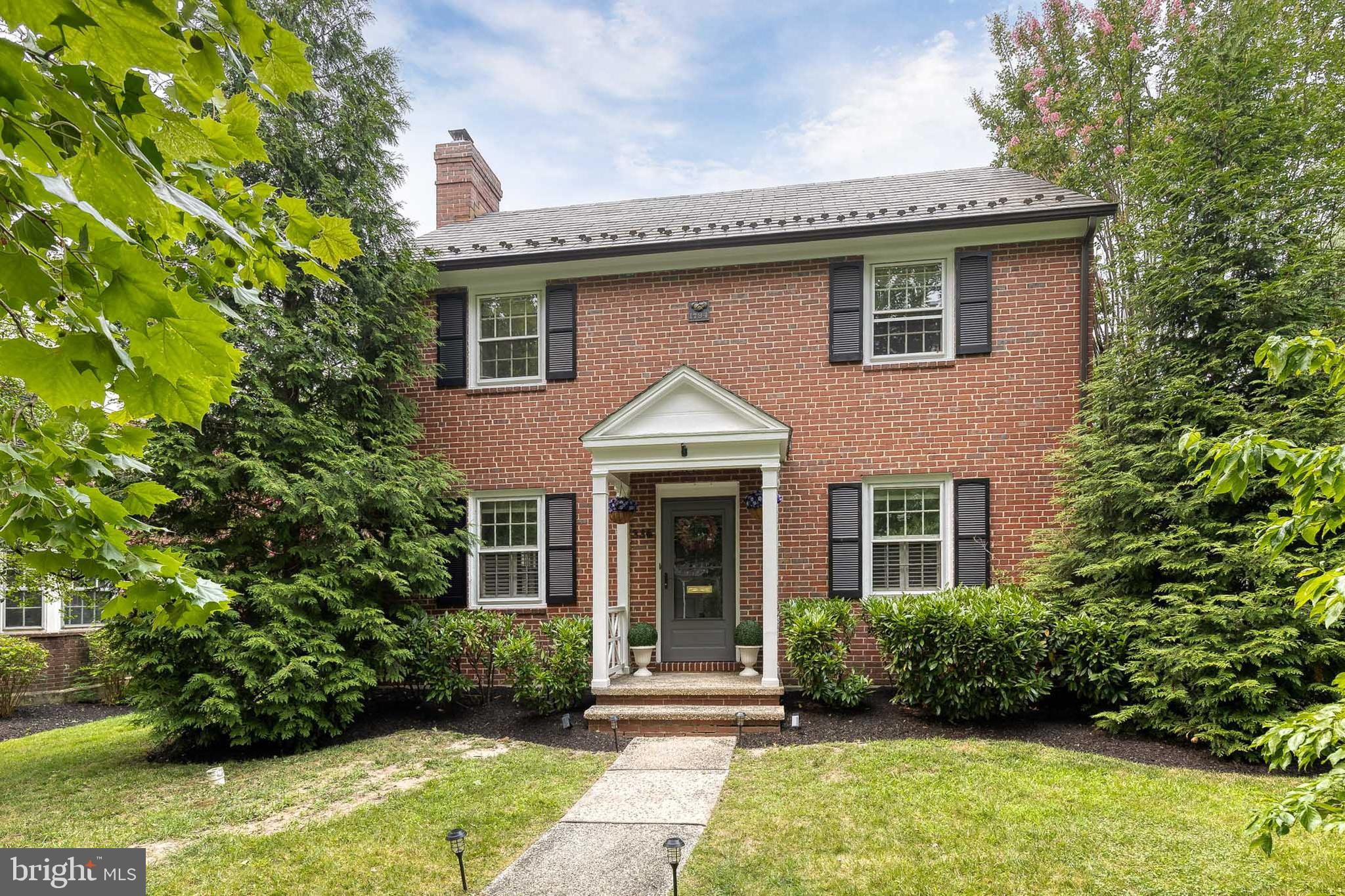 Nestled in the heart of the sought-after Homeland Historic District, this timeless 4-story brick Colonial offers 4 bedrooms, 3.5 bathrooms, and classic architectural charm paired with thoughtful updates. The inviting living room showcases hardwood flooring, crown molding, custom built-ins, and a cozy wood-burning fireplace. Continue to the elegant dining room featuring continued hardwood floors, crown molding, a beautiful bay window, striking moody blue walls, and chandelier lighting, creating the perfect setting for entertaining.

The dining room flows into the spacious kitchen, complete with granite countertops, heated slate tile flooring, stainless steel appliances, a pantry, and abundant cream-colored cabinetry. The adjoining breakfast room also features heated slate tile flooring and a ceiling fan, with direct access to the backyard. Just beyond is a convenient mudroom and a beautifully designed full bathroom with playful designer wallpaper and a tiled stall shower.

The second level offers hardwood flooring throughout and includes a spacious primary suite filled with natural light, dual closets, and a private en-suite bath with a tiled tub/shower. Two additional bedrooms and a full hall bath complete this level, while the finished top floor provides a versatile fourth bedroom, perfect for guests, a home office, or creative space.

The finished lower level features a large recreation room with recessed lighting, a convenient half bath, laundry, and additional storage. Outside, enjoy the expansive, beautifully manicured backyard with a spacious blue stone patio surrounded by mature trees, offering a private retreat for relaxing or entertaining. A one car garage finishes the space off to add ample parking or storage. A rare opportunity to own a classic Homeland home filled with character, space, and modern comforts. Welcome home!