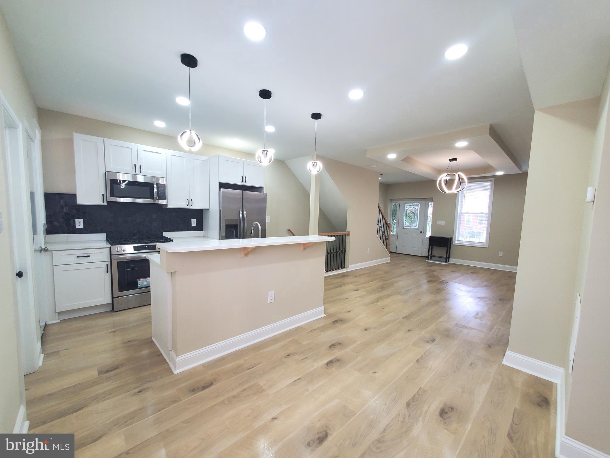 Stunning Fully Renovated Home with 3 Bedrooms, 3 Full Baths, Master Suite, Home Office & Privare 
2-Car Parking  Pad!  Exceptional renovation from top to bottom with open floor plan, beautiful laminated flooring, fully finished basement with ceramic flooring, washer, dryer, walkout patio , two level deck, private fencing and more.  All major systems including  new heating, forced-air HVAC, plumbing, electrical with 200 amp service.  

This open concept main level boast into an elegant layout & lighting with 2 electrical fireplaces, recess lighting, leading into a chef's delight kitchen with a large center island, new built-in stainless steel microwave, stainless steel refrigerator, stove and dishwasher, ceramic backsplash.  Walk-in pantry with deep freezer and shelves for food storage.

First-time homebuyers are welcome, seller assistance is available, and a home warranty is included, making this an incredible opportunity you don't want to miss.  Schedule you private showing today!