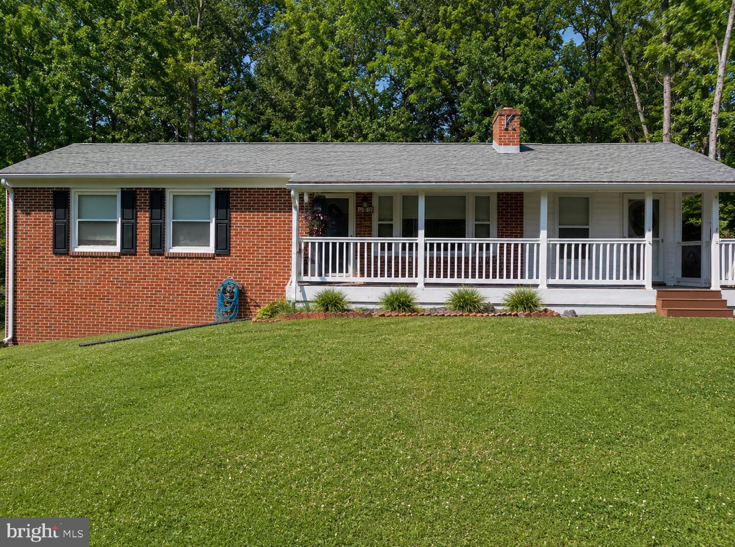 Welcome home to this well-maintained ranch offering the perfect blend of comfort, versatility, and convenience on a .61-acre unrestricted lot with no HOA! Ideally located on the outskirts of Spring Mills and Falling Waters, this spacious 3-bedroom, 2.5-bath home boasts over 2,000 square feet of living space plus a partly finished basement. Step inside to discover a warm and inviting living room featuring a cozy wood-burning fireplace. The large country kitchen is sure to impress with Corian countertops, beautiful oak cabinetry with convenient pull-out drawers, and an adjoining dining area. A den provides additional living space for a home office, playroom, or reading retreat. Luxury vinyl plank, wood and vinyl flooring, recessed lighting, and ceiling fans add style and comfort throughout.  The main level offers a spacious primary bedroom, two additional bedrooms, a full hall bath, and a laundry room with washer and dryer hookups and a convenient half bath. Downstairs, the partly finished basement expands your options with a family room, exercise or hobby room, full bath, second laundry area, and utility room.  Enjoy outdoor living from the screened back porch or covered front porch with Trex decking. Additional highlights include a wood-burning outdoor furnace, detached one-car garage, carport, and two storage sheds. Conveniently located with easy access to Virginia, Maryland, and the MARC Train. Schedule your private tour today and discover all this wonderful home has to offer!