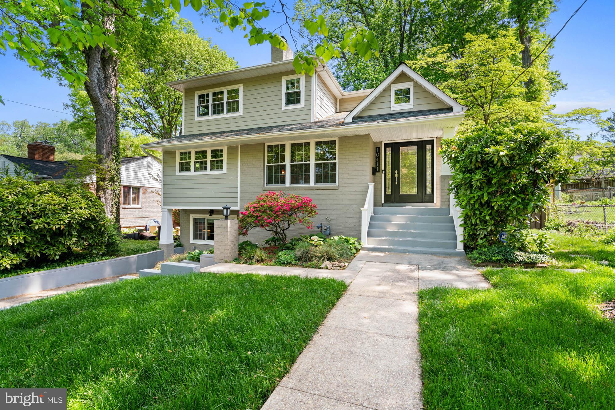 Expanded. Elevated. Easy to Love. More updates and upgrades than can be counted, this light-filled, expanded Cape Cod in the heart of Kensington has been transformed from top to bottom. With four bedrooms, three-and-a-half bathrooms, this is the one that finally checks every box! Every system, every finish, and every space has been upgraded with long-term comfort in mind. From the dual-zone HVAC with Nest thermostats, new PVC plumbing, and Takagi high-efficiency tankless water heater, to the upgraded electrical panels and EV charger, the infrastructure is set. All you have to do is move in and enjoy.
The covered front porch sets the scene, inviting you into a sunny living room with oversized windows, refinished hardwood floors, crown moldings, and a wood-burning fireplace. The heart of the home -- a brand-new chef’s kitchen -- features Wolf and Bosch appliances, premium cabinetry, quartz countertops, and a center island with breakfast bar. The great room is anchored by another fireplace and sliding glass doors to the Trex Transcend deck overlooking the level, fenced backyard. The main level also includes two bedrooms (one currently configured as a home office), and a full hall bath, in addition to a modern powder room discreetly tucked away for convenience. Upstairs is your private owner’s suite: a sunny bedroom with a generously-sized walk-in closet, an updated en suite bath with sleek finishes, and a reconstructed, waterproofed balcony overlooking the garden and treetops. Downstairs, the finished lower level features new carpet, an expansive rec room with wet bar and beverage fridge, a home gym or creative nook, a renovated full bathroom, the fourth bedroom, laundry area, and smart storage solutions throughout. Outdoors, mature landscaping, a six-foot rear fence, new French drain, and multiple spaces for relaxing or entertaining including a rear patio, side porch, and the deck. All of this, just steps from Homewood Park, Kensington Farmer’s Market, and Antique Row. MARC and Metro make commuting a breeze, with Walter Reed, NIH, Downtown Bethesda, Montgomery Mall, and Pike & Rose just minutes away. 10411 Drumm Avenue offers the rare combination of comfort, craftsmanship, and convenience -- a true turnkey experience in a beloved community where pride of ownership shines.