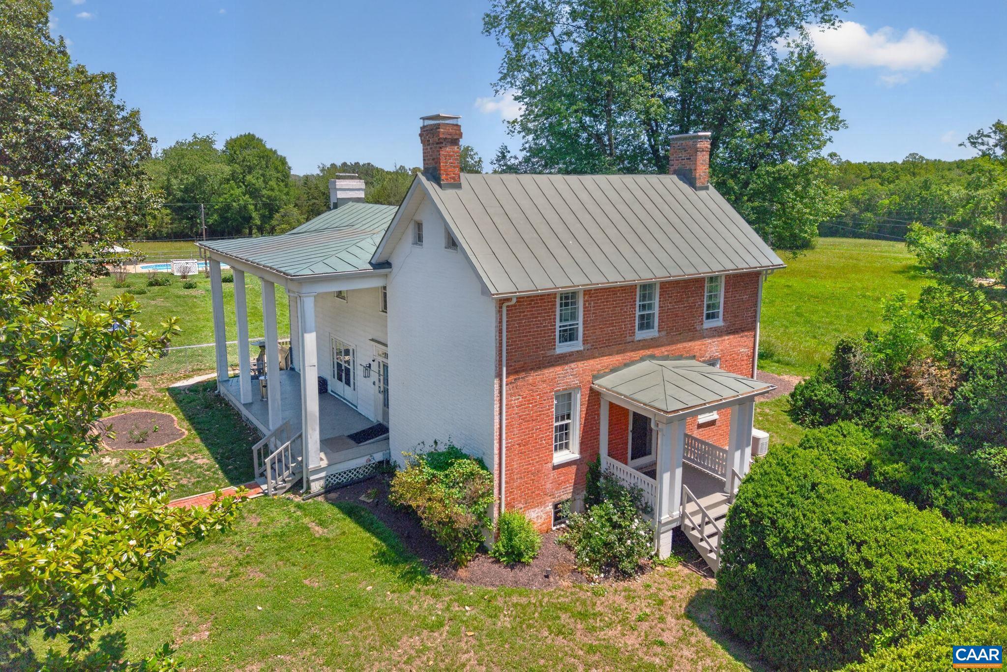 Three Chopt Acres is an Historic Virginia Farmhouse on 10+ Acres.  Experience the timeless charm of this classic 1802 Virginia farmhouse, gracefully situated on just over 10 acres of open countryside surrounded by picturesque horse farms and rolling pastureland. Rich in character and history, the home features beautiful hardwood floors throughout, blending period craftsmanship with the comforts of country living.  The property offers abundant space for entertaining and outdoor enjoyment, highlighted by a refreshing swimming pool and expansive grounds with breathtaking rural views in every direction. A detached twin-bay garage provides ample room for vehicles, equipment, or workshop space.  Garden enthusiasts will appreciate the generous acreage and full-day sunlight, creating ideal conditions for vegetable gardens, flowers, or hobby farming. The fenced backyard offers a secure and convenient space for dogs to roam and play.  Whether relaxing by the pool, hosting family and friends, cultivating a garden, or simply enjoying the peaceful setting, this remarkable property presents a rare opportunity to own a piece of Virginia history in an idyllic countryside location.,Fireplace in Master Bedroom
