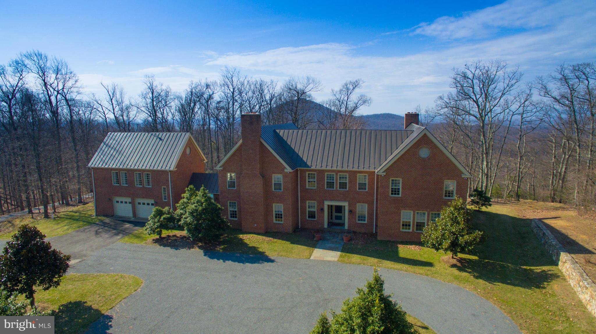 165 +/- acres on Little Cobbler with amazing views of Big Cobbler and the Blue Ridge Mountains! Pond, Open Land, Pool, Hot Tub, 4 Lvls, 4 BR, 4 BA Brick Home w/2 Bay Garage/Guest quarters to the left of main residence, Machine Shed, Screened Porch, Wet Bar, Large Stone Courtyard and Terrace, Full House Generator, 3 Fireplaces, Approx.6,500 sq.ft. Property is in Land Use and includes 2 parcels.