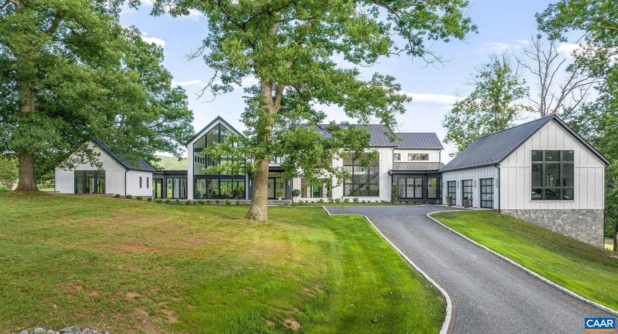 Sited beautifully amongst massive oak trees, this dazzling home enjoys incredible views of rolling hills & the mountains beyond, to the front and rear of the residence. The centerpiece of the interiors is a great room that soars to 31 feet with walls of glass to take in the views. Other ceilings are 10-11ft.  Dramatic stone & tile selections throughout. 1st floor master plus an additional 1st fl bedroom suite that doubles as a home office. 3 bedroom suites up and guest suite in the basement. A large, covered rear porch is ideal for entertaining next to the horizon pool. Features incl' wide plank oak flooring on all 3 floors, geothermal HVAC, home gym, and butler's pantry. Comprised of two 21 acre parcels, one of which fronts on Red Hill Rd, the property enjoys 2 entrances & can be subdivided. Below the house is a large, multi-purpose barn with half bath, devoted septic. Horse friendly land! Lovely, bold creek traverses the property. 15 gallon per minute well.  Fiber optic internet. 12 minutes to town, Boar's Head, Farmington et al,Marble Counter,Fireplace in Great Room