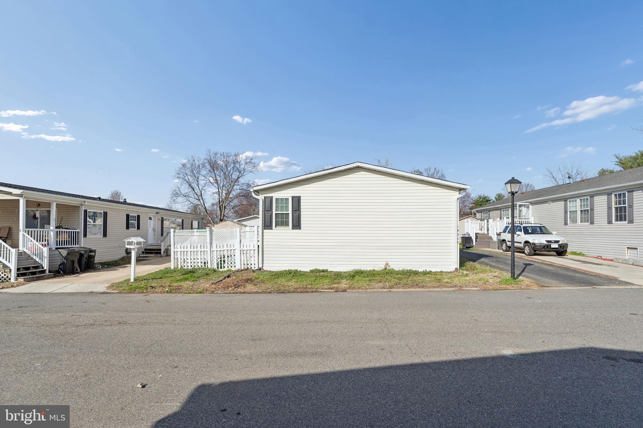 This is a manufactured home in a managed park.  All buyers must be approved by Meadows of Chantilly.  The current Land Rent is $1878/month.  Buyers can pay cash or secure private financing to pay for the house.
4 bedrooms and 2 remodeled bath rooms.  Bamboo and laminate floors throughout.  Living room with fireplace.   Remodeled kitchen with white cabinetry, Quartz counters and stainless appliances.  New Windows.  Fenced yard with a deck.  Driveway and a large storage shed.  Community clubhouse, pool, workout room, tot lot and basketball court.  Ideal commuter location near Routes 50, 28, the Dulles Toll Road, and I-66. Walk to shopping and restaurants.