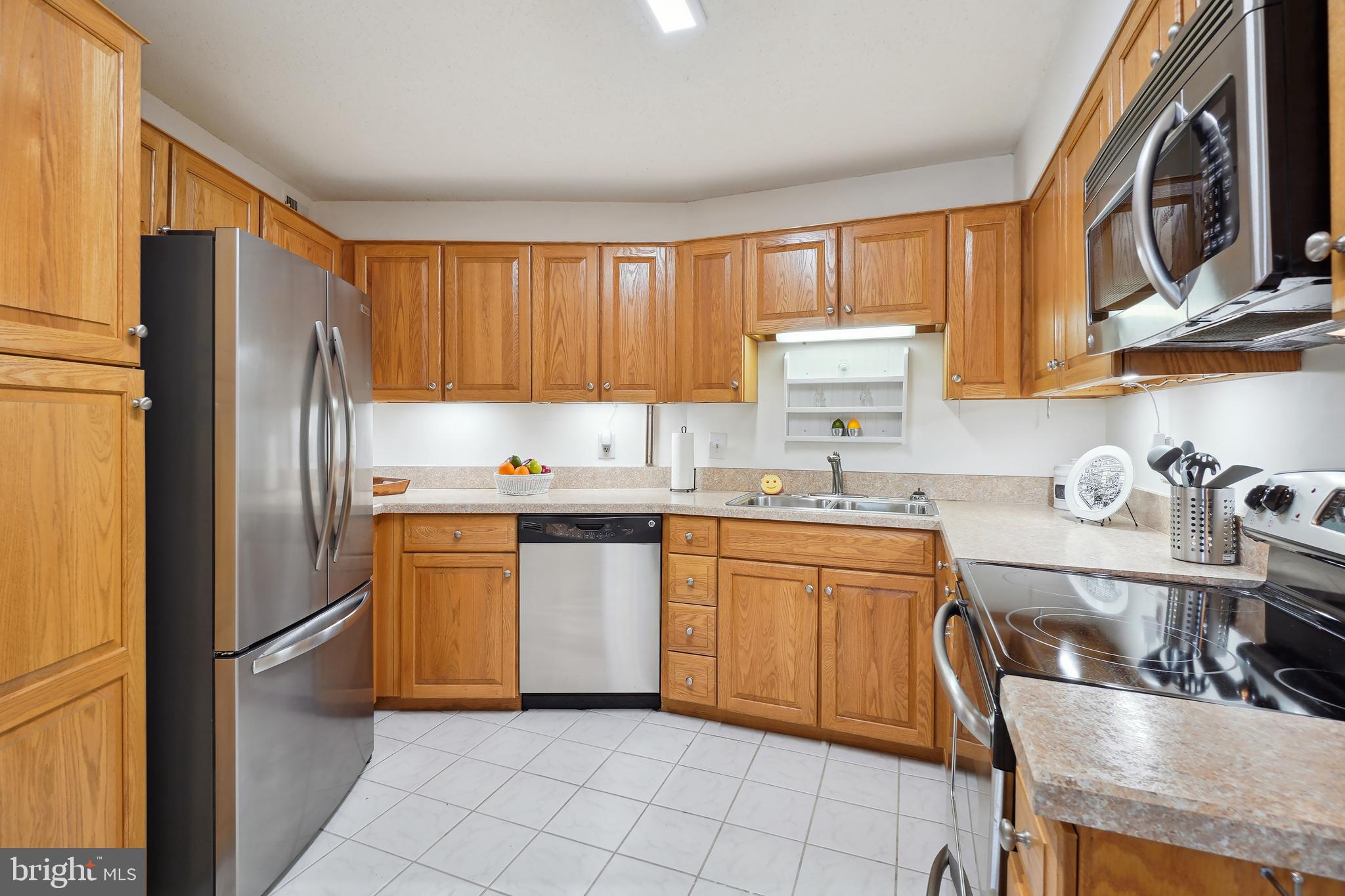 Enjoy access to all of the  amenities Leisure World has to offer when you move into this bright and sunny 5th floor condo with new fresh paint, laminate plank flooring and carpeted bedrooms. Separate Laundry closet and a spacious hall pantry are a real plus. The kitchen was previously undated and includes  all stainless appliances. Recent bedroom carpet and new commodes in both bathrooms. There is, also.  a  storage cage located on the building lower level.  The expansive glass enclosed balcony has a sunny panoramic golf course view.  Leisure World is a 55+ community that has both an HOA and Condo Association.  In addition there is an 18 hole golf course, indoor and outdoor pools and a well equipped fitness center is open to all residents in Club House II. There are many clubs and activities, including tennis courts, prickle ball, a fantastic wood working shop in Club House 1 and a grand ballroom which hosts a multitude of events through the year. T