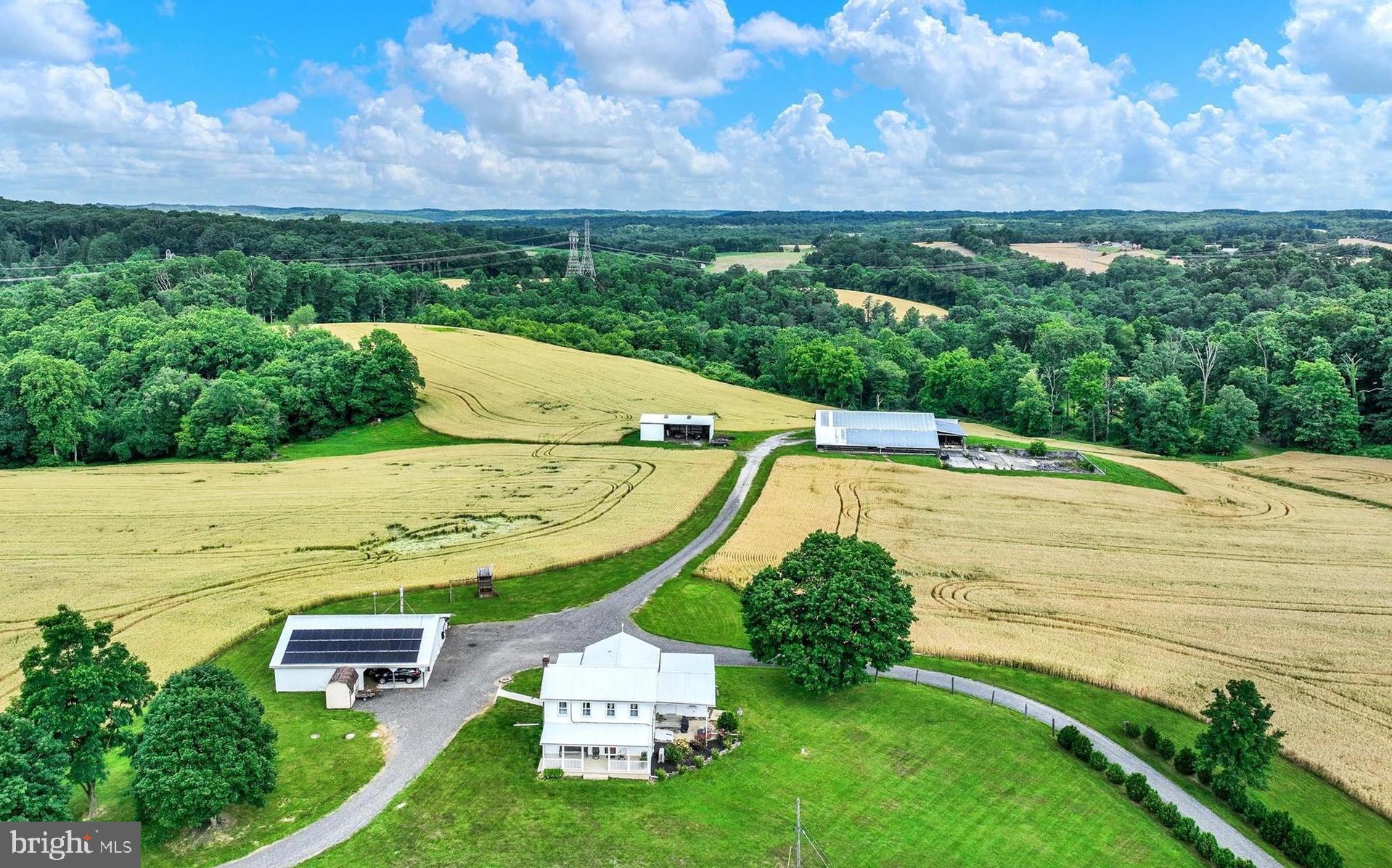 Welcome to the epitome of rural living in the heart of Northern Baltimore County's prestigious Hereford Zone. Nestled on a sprawling 149-acre farm, this property offers a splendid farmhouse experience with modern amenities and abundant space for both living and cultivation. The main farmhouse boasts 3 bedrooms and 2 full baths, adorned with charming exposed ceiling beams and classic wood floors throughout. A spacious country kitchen serves as the heart of the home, perfect for gatherings and culinary adventures. Additionally, the attached in-law quarters provide private accommodation with 1 bedroom and 1 full bath, ideal for multi-generational living or guest quarters. The in-law quarters offers a separate ramped entrance. This well maintained property features central air conditioning, replacement windows, and an updated kitchen, ensuring comfort and convenience. Outside, a detached garage/workshop equipped with an electric hydraulic lift offers ample space for vehicles and projects.
For the equestrian enthusiast or hobby farmer, anticipating having livestock,  the expansive grounds include a 110' X 70' barn with 13 stalls, previously utilized for beef cattle, and a 54' X 30' equipment shed. Approximately 70 acres of tillable/pasture land provide opportunities for farming or grazing, while 60 acres of wooded terrain offer tranquility and natural beauty. As a bonus, the property benefits from solar panels (currently leased and transferable), offering sustainable energy solutions and potential cost savings. A stream meandering through the landscape adds to the picturesque setting, enhancing the property's allure. Situated in the highly sought-after Hereford School Zone and encompassed by Maryland Agriculture Land Preservation Foundation (MALPF) easement, this farm presents a rare opportunity to embrace a serene lifestyle while preserving the rich agricultural heritage of the region. Don't miss your chance to own a piece of paradise in this coveted locale. Schedule your private tour today and experience the charm and potential of this remarkable Hereford Zone farm.