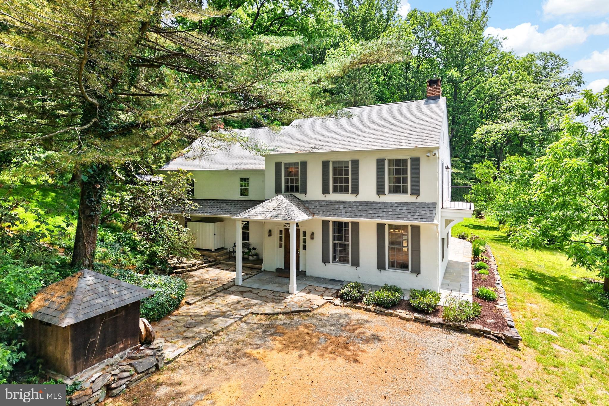 Overlooking a protected waterway, this 3 BR, 2.5 bath traditional-style home is on 8 acres. There is great historical appeal to this property. The 3,578 square-foot above-grade 8 room residence was originally built in the mid 1800’s, renovated  in 1997 and extensively updated since. Its historic bones reach back to its days as a millers house. Indeed, the old mill race and mill foundation ruins are still part of this one-of-a-kind property located in the Avon Grove School District.

The house is a combination of stucco over stone and white painted clapboard wood siding, and features a charming covered entrance. Wood floors throughout, 2 operational wood stoves and 1 decorative FP; sunny country-style updated kitchen with stainless dishwasher and stove, large center island, mudroom off kitchen with outside entrance. Ceiling fans throughout.

Exposed stone walls lead up the staircase from 1st to 2nd floor. Bright and airy 2nd floor redone primary BR with built-ins, separate dressing room or could be a perfect nursery and 2 private decks; 2nd floor laundry room, plus 2 more BRs and a full bath. A separate room on the main floor that houses the utilities.

Loads of improvements throughout since its last purchase in 2022, Including a new HVAC System and added A/C to the old part of the house; new septic system; new roof;  new refrigerator; new kitchen sink and faucet; and new under-sink reverse osmosis system. 

Outside arborist services have removed dead trees surrounding house; added gravel access paths between old railroad bridge abutments; done extensive land clearing, clearing of hiking trails up to walkable former railroad line, which is now a designated trail; added bonfire pit behind garden shed. There is new planking on the bridge drive and newly built custom planter box covers for septic system.

Flagstone terraces outside; mature trees, many of which are spring-flowering. Three outbuildings: a detached garage with attached shed storage space, another separate shed and a lean-to for wood storage. A large pond, that is an offshoot of the original mill race adds to the appeal.

This is a charming property with a lovely water view. It is a quiet, well-protected and private property on the banks of the White Clay Creek, a federally designated Wild and Scenic River that is regularly stocked with trout, and private bridge access. 

It spans two townships, New Garden and London Britain, in Chester County. Its south edge borders the White Clay Creek Preserve (Pa.) and, further south, its 3,000 acre sister preserve in Delaware, the White Clay Creek State Park. 

Really great outdoor recreational opportunities abound, especially mountain biking. Or you can wade in and fly fish right from your front yard! Easy walk via wooded trails to the center of the iconic village of Landenberg.