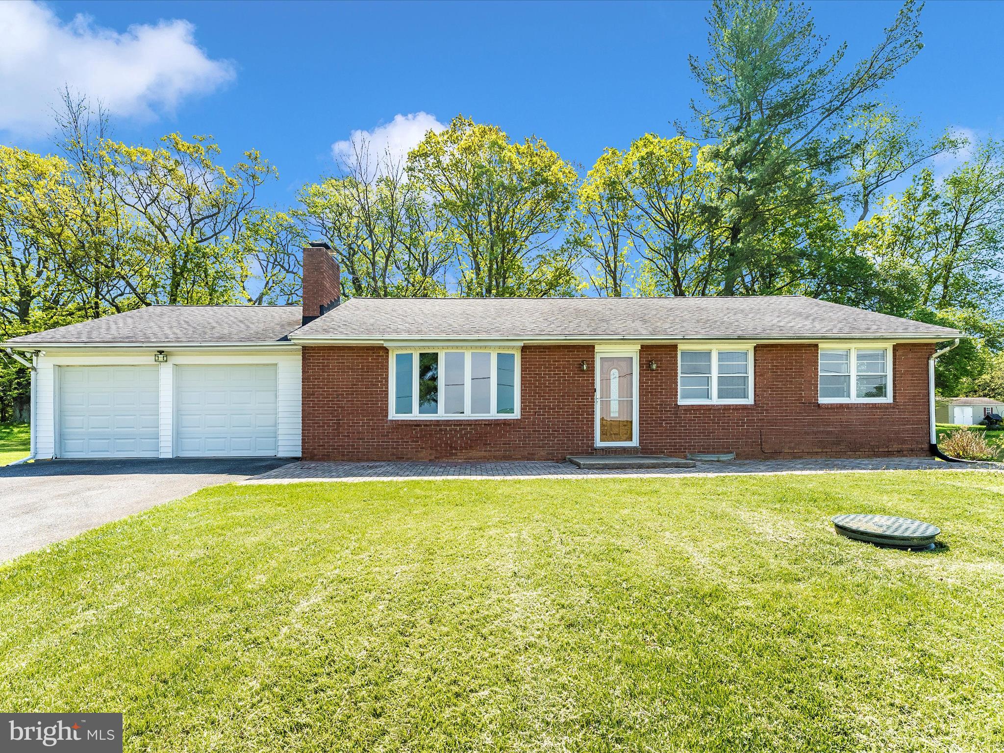 This beautifully updated brick rancher sits on a spacious, level lot backing to mature trees, offering privacy and peaceful outdoor living. Step inside to find freshly painted interiors and gleaming hardwood floors throughout the main level. The oversized family room features a cozy fireplace and a bright bay window that fills the space with natural light.

The kitchen boasts durable LVP flooring and flows into a separate dining room—perfect for gatherings and daily meals. Down the hall, the primary suite includes a private bath with an updated vanity and a beautifully tiled walk-in shower. Two additional generously sized bedrooms and a second full bath complete the main level.

The fully finished basement adds even more living space with LVP flooring, a large rec room, a fourth bedroom, and abundant storage. An oversized two-car garage offers plenty of room for vehicles and hobbies.

Located in sought-after Urbana, this home combines space, comfort, and convenience—don’t miss your chance to make it yours!