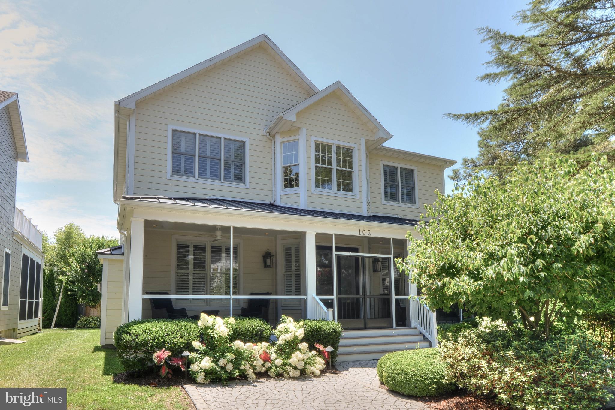 This stunning South Rehoboth home is situated on one of the most desired streets in town. 102 St. Lawrence Street is located less than 1.5 blocks from the ocean and boardwalk and just steps to Rehoboth’s shops, restaurants, and more. The beautiful landscaping, paver driveway and large screened porch contribute to this home’s charming curb appeal.  Upon entry, you will be impressed by the soaring ceilings, custom trim and moldings at every turn and tasteful décor. The floor plan offers a spacious living room with fireplace and custom built-in surround, dining room ideal for family gatherings, a gorgeous new kitchen featuring stainless appliances, quartz counters, a spacious breakfast bar and eat in breakfast nook. The 4 bedrooms include two beautiful master suites located on the 1st and 2nd level. In addition, 102 St. Lawrence offers superb outdoor living spaces including 2 screened porches, an open deck perfect for grilling, 2nd level sun-deck with views of Silver Lake, an outdoor shower with changing room, and a spacious storage shed for all of your beach toys. This home has been impeccably maintained and having undergone various updates since 2015, this home is practically like new. Overall, the renovations have included a total exterior makeover (decks, porches, railings, roof, siding, etc.), brand-new kitchen, 3 new bathrooms, new laundry room and much more. Being sold fully furnished with few exclusions, this home offers an excellent opportunity to own your beach home in one of Rehoboth's areas most sought after locations!