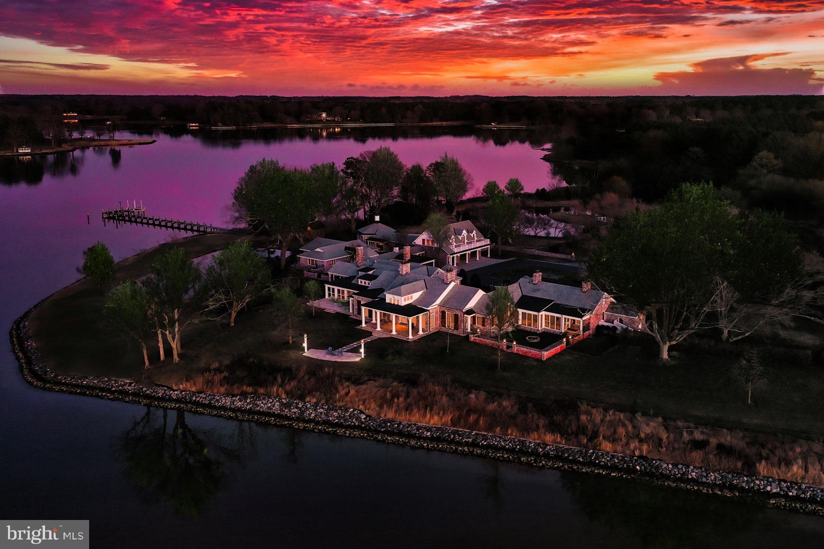 Explore the allure of this hidden jewel in Oxford where refined luxury merges effortlessly with coastal charm. Nestled across 20+ elevated acres, spend your days meander through covered walkways, cobblestone paths, ornamental trees, scenic gardens, and panoramic point-of-land views that captivate the senses. Originally constructed in 1938, Widgeon Point has undergone a complete transformation by skilled artisans and architects, resulting in a stunning residence with guest house, pool house and detached garage with apartment above. Upon entering the main home, the attention to detail is on full display through the intricate millwork, meticulously laid hardwoods, heated Tennessee stone floors, and finely crafted fireplaces. Whether you're working, unwinding, dining or entertaining, this thoughtfully designed home accommodates your needs with unparalleled ease. The provincial kitchen offers professional-grade appliances, a farmhouse sink, and plentiful custom cabinets with granite-topped counters, all chef approved for facilitating the creation of cherished meals. The adjacent dining room, with  wet bar, sets the stage for celebrations big and small, while enclosed gazebos and expansive outdoor patios offer perfect settings for gatherings with views of yachts and unforgettable sunsets. At the end of the day, retreat to four bedrooms, each offering perfect accommodations with privacy, and bathrooms adorned with hand-selected stone. The primary bedroom suite boasts, cozy fireplace, spa-like bath and tranquil sunroom overlooking the estate with panoramic views of Trippe Creek. The secondary Primary bedroom suite offers over 1000 sqft of comfy respite, fireplace, and bay window. Guests will appreciate the added option of the two-bedroom guest house and fully independent over-garage apartment. Embrace the outdoors by lounging around the saltwater pool and the pool house with conveniently located kitchen and bathroom, perfect for summer relaxation. And don't forget to explore the 2 private ponds including one with serene island only accessible by a charming footbridge , the caretaker cottage, boathouse, three-car garage, and two barns. The deep-water dock beckons you to launch cruises to discover endless watershed adventures in the surrounding coves, rivers, and sanctuaries that cater to the boating enthusiast or spend the day exploring nearby historic townships like Oxford and Easton, with their plethora of restaurants, golf courses, artful shops, and annual festivals. This exceptional property invites you to experience a lifestyle where refined living seamlessly merges with coastal tranquility. Welcome Home!