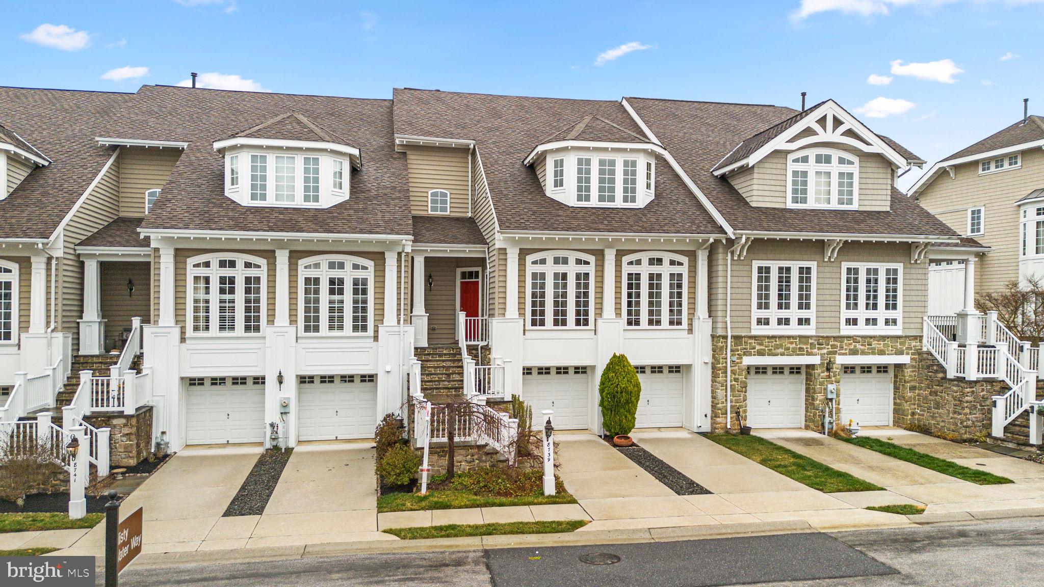 Transitional townhouse with breathtaking lake views offering 2,865 square feet, 3 bedrooms, 2 full baths, 2 half baths, and a 2-car garage in Howard County's premiere gated community, Stone Lake, which boasts waterfront amenities alongside the pristine 25-acre lake. 

The expansive open-concept main level features gleaming hardwood floors that flow from the foyer into the combined living and dining room, accented by elegant chair rail detailing and a sophisticated chandelier. Hardwoods continue past a convenient powder room into the spacious eat-in gourmet kitchen, which boasts an island breakfast bar illuminated by elegant pendant lighting, ample cabinetry and counter space, a stylish backsplash, a stainless steel refrigerator, and white appliances that seamlessly complement the bright and airy design. The sunlit breakfast area provides exterior access, while the adjacent family room serves as the heart of the home, featuring a gas-burning fireplace framed by built-ins.

The upper level offers a laundry room and two bedrooms, including the luxurious primary suite with a striking two-story vaulted tray ceiling, a sitting area, two walk-in closets with organization systems, a private upper balcony, and an ensuite bath. The spa-like bath includes separate vanities and water closets, dual access to the shower, a dedicated makeup station, and a soaking tub with serene lake views. The second bedroom features a walk-in closet and an attached full bath.  The lower level includes a third bedroom, a full bathroom, a utility room, and a bright, open recreation room with plush carpeting and exterior access.

Outdoor living is elevated with an expansive deck, a bluestone patio featuring a gas fireplace, and stunning views of the tranquil woodland and lake. Community amenities include tennis courts, a putting green, a playground, scenic lakeside paths and pavilions, and access to various water activities.