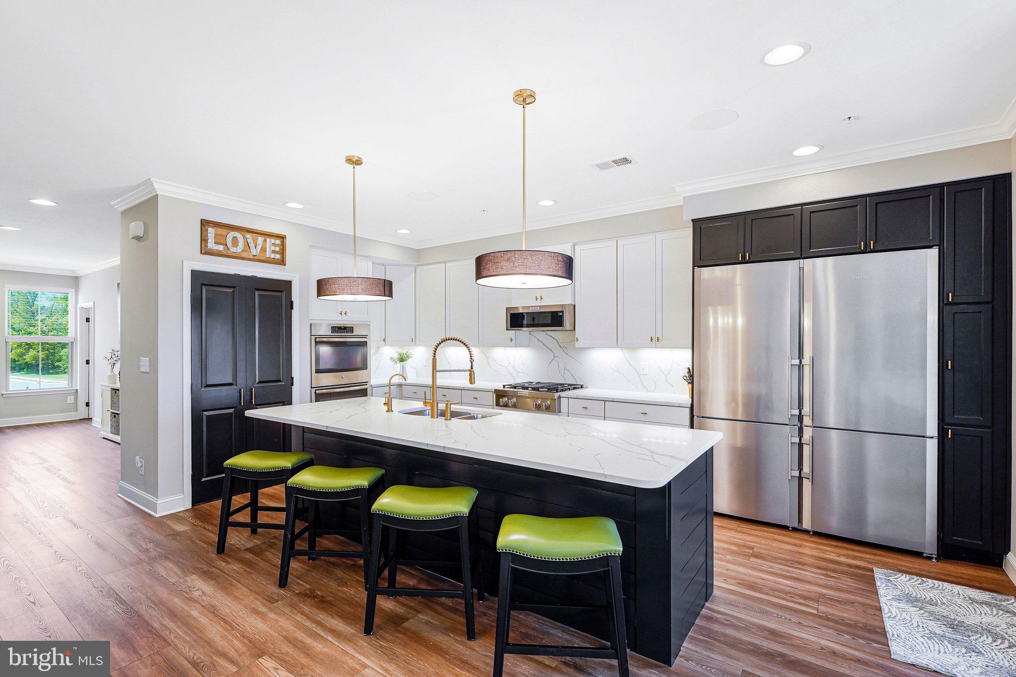 Welcome to this beautifully upgraded Picasso upper-level end-unit condo offering the perfect blend of luxury, functionality, and convenience. Featuring 3 bedrooms, 2.5 baths, and two dedicated sound insulated home offices, this thoughtfully customized home maximizes every inch of living space. The offices were intelligently created from the traditionally underutilized living and dining room areas, providing ideal work-from-home flexibility without sacrificing comfort or style. Enjoy peaceful tree views from the private open balcony and the added convenience of virtually unlimited overflow parking nearby along Kinsale Blvd. The recently remodeled interior showcases extensive high-end upgrades throughout, including luxury vinyl plank flooring across the main level and upper hallway, upgraded crown molding and baseboards throughout the main level, tailored luxury lighting, and professional solar window film for enhanced energy efficiency and reduced glare. The stunning gourmet kitchen is the centerpiece of the home, featuring an expanded approximately 10’ x 4’ quartz island with matching quartz backsplash, a massive 60” x 80” Liebherr refrigerator with dual ice makers, KitchenAid commercial-grade range top, slimline microwave, dishwasher, under-counter beverage and wine cooler, commercial-grade water filtration system with dedicated faucet, and upgraded sink, faucet, and disposer. Additional luxury features include distributed audio in the main living area and primary bedroom, 5.1 surround sound wiring in the primary bedroom sitting area, custom 2” wood blinds throughout, room-darkening Roman shades in the bedrooms, custom closet organizers, and a built-in Frontgate jewelry cabinet. The finished garage is equally impressive with an epoxy-coated floor and EV charging outlet, completing this truly move-in-ready home loaded with premium upgrades and modern conveniences.