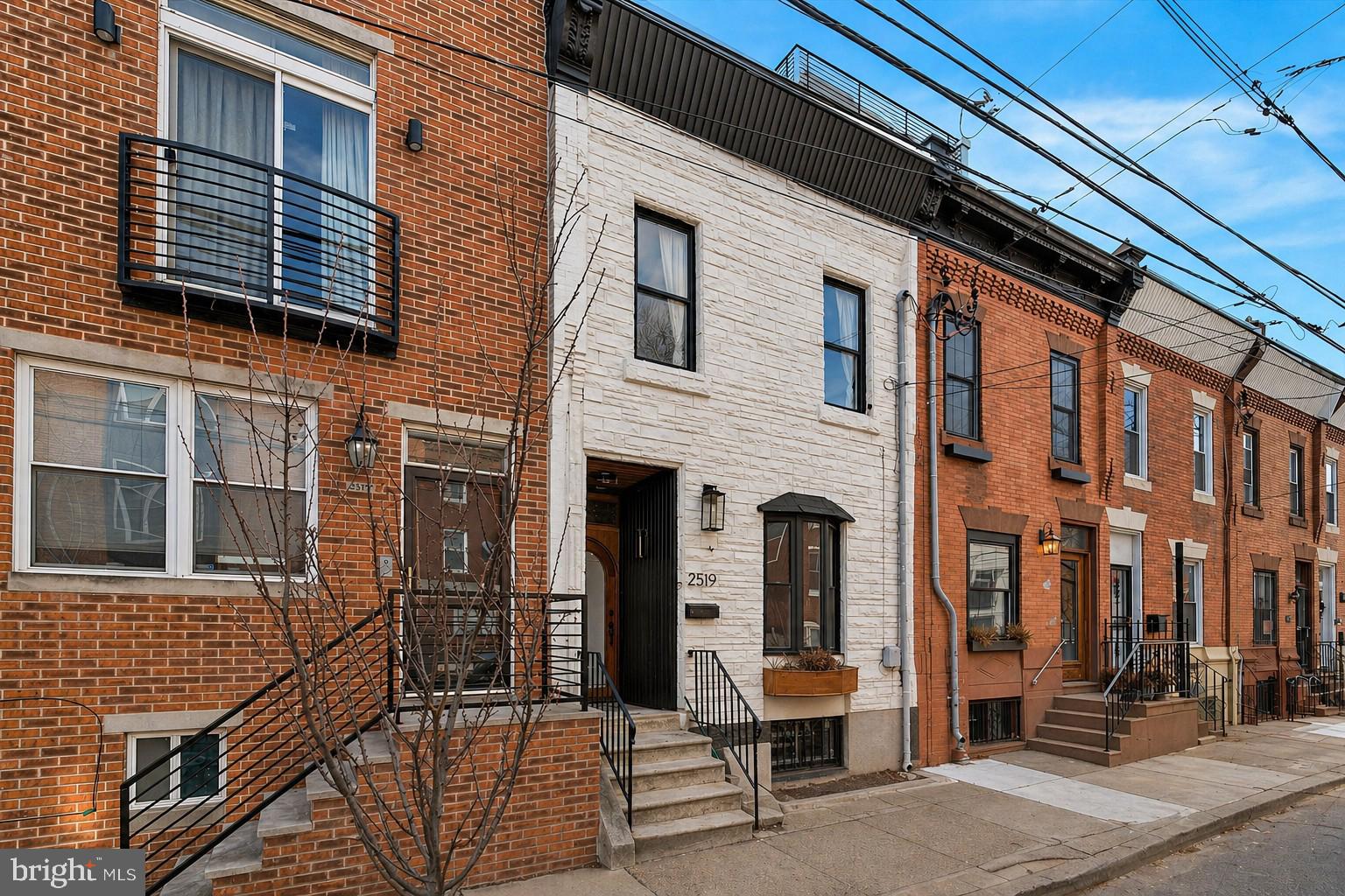 Welcome to 2519 Grays Ferry Ave in Graduate Hospital, a beautifully renovated home that seamlessly blends timeless Philadelphia character with modern finishes in one of Philadelphia’s most sought-after neighborhoods. Situated on a quiet, tree-lined block, this impeccably maintained residence offers exceptional natural light, generous living space, and thoughtful upgrades throughout.

From the moment you arrive, the home’s charming curb appeal stands out with a beautifully arched, set-back front entryway that adds warmth and architectural character. Inside, you’ll find soaring ceilings, original hardwood floors, recessed lighting, and exposed brick accents that create the perfect balance of historic charm and contemporary style.

The sun-drenched main level features a seamless open-concept layout ideal for entertaining and everyday living. The spacious living and dining areas are anchored by exposed brick and stylish finishes throughout, while the renovated kitchen offers granite countertops and backsplash, stainless steel appliances, new cabinetry, pendant lighting, and abundant prep and storage space. A convenient powder room completes the first floor.

Upstairs, the home features three spacious bedrooms plus an additional office space, providing flexibility for remote work, guests, or a nursery. The bright primary suite is enhanced by oversized windows, bay frontage, excellent closet space, a custom luxury bath, and additional exposed brick details that add warmth and sophistication. Updated bathrooms throughout the home showcase clean, modern finishes and thoughtful design.

The enormous lower level boasts impressively high ceilings and offers incredible potential for additional finished living space, whether envisioned as a media room, gym, recreation area, or guest suite. Outdoor living is equally impressive with a large rear yard perfect for entertaining, dining, or relaxing outdoors. The home also offers exciting future upside, as several neighboring properties have added a third level and rooftop deck expansion to maximize skyline views and overall property value.

Additional highlights include updated plumbing and electrical systems, excellent storage, and an unbeatable Walk Score of 91. Enjoy close proximity to top-rated restaurants, cafés, grocery stores, gourmet markets, Schuylkill River Park, the Schuylkill River Trail, Rittenhouse Square, University City, University of Pennsylvania, Children's Hospital of Philadelphia, 30th Street Station, public transit, and all major highways. This is Philadelphia city living at its absolute finest.